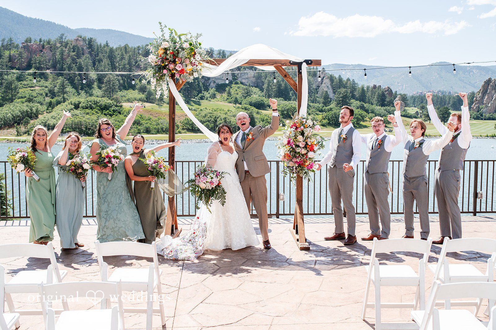 Mckenna + Ryan A bridal party standing under a wooden archway during an ceremony.