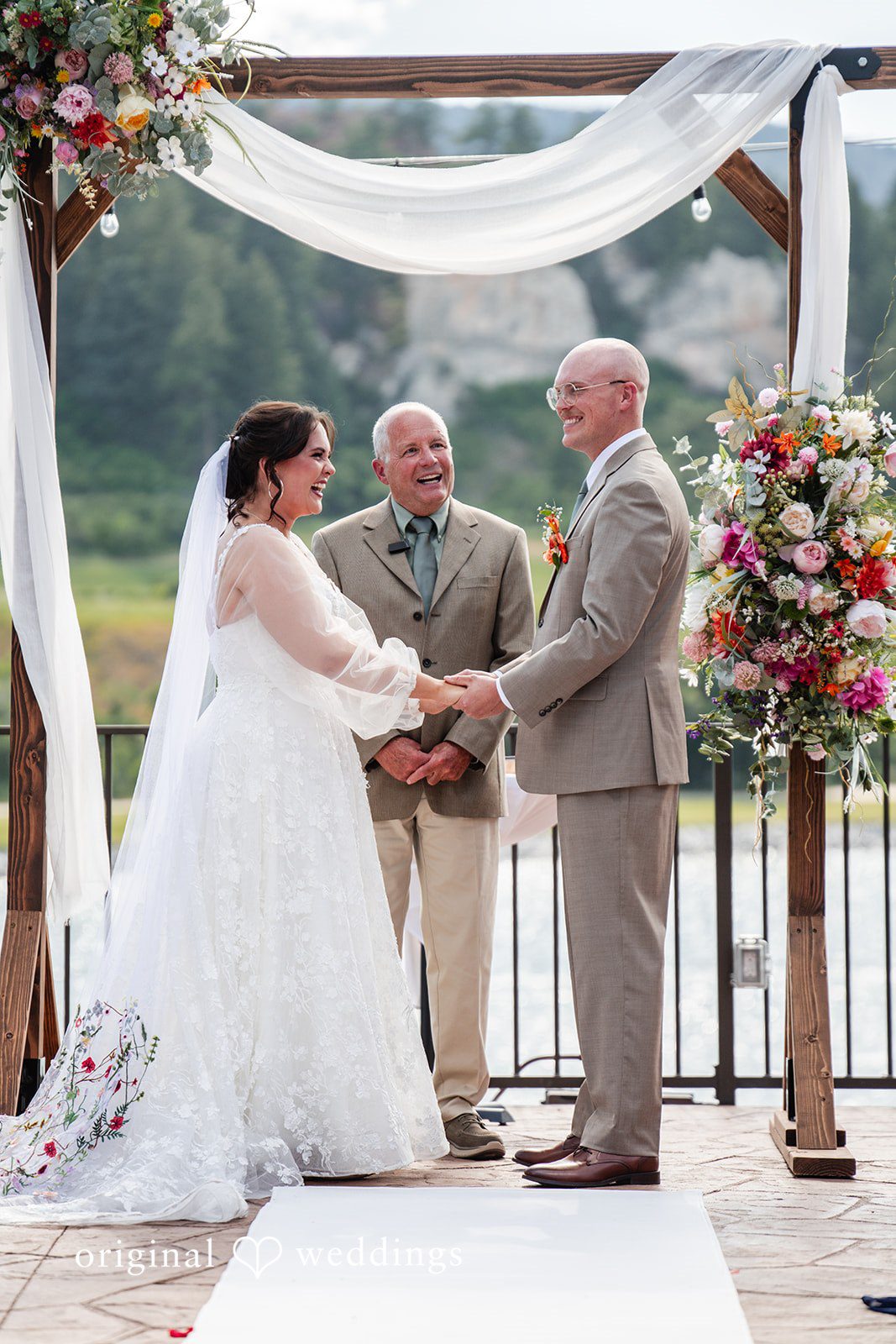 Mckenna + Ryan A bride and groom exchanging vows at an altar.