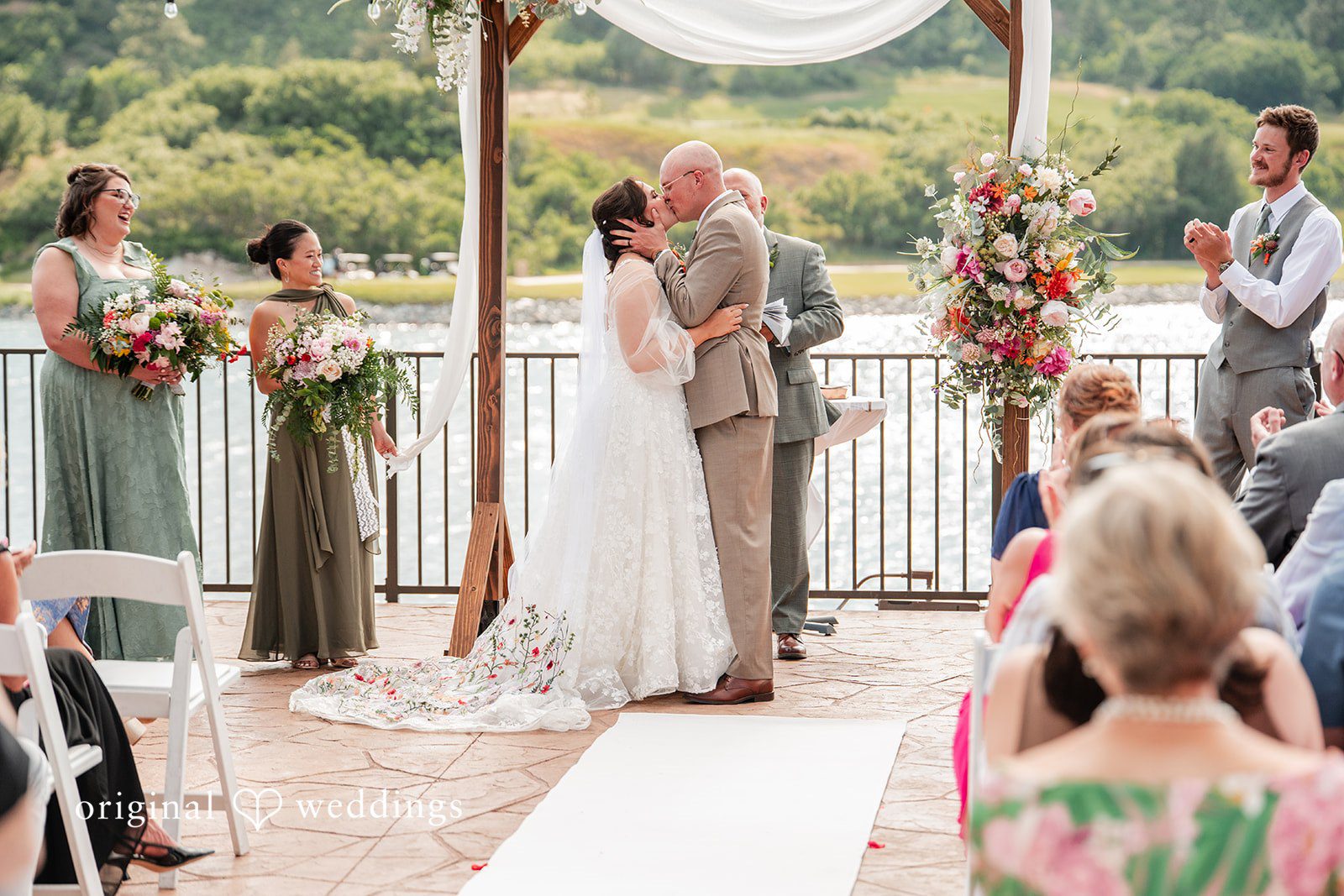 Mckenna + Ryan A bride and groom kissing during their ceremony.