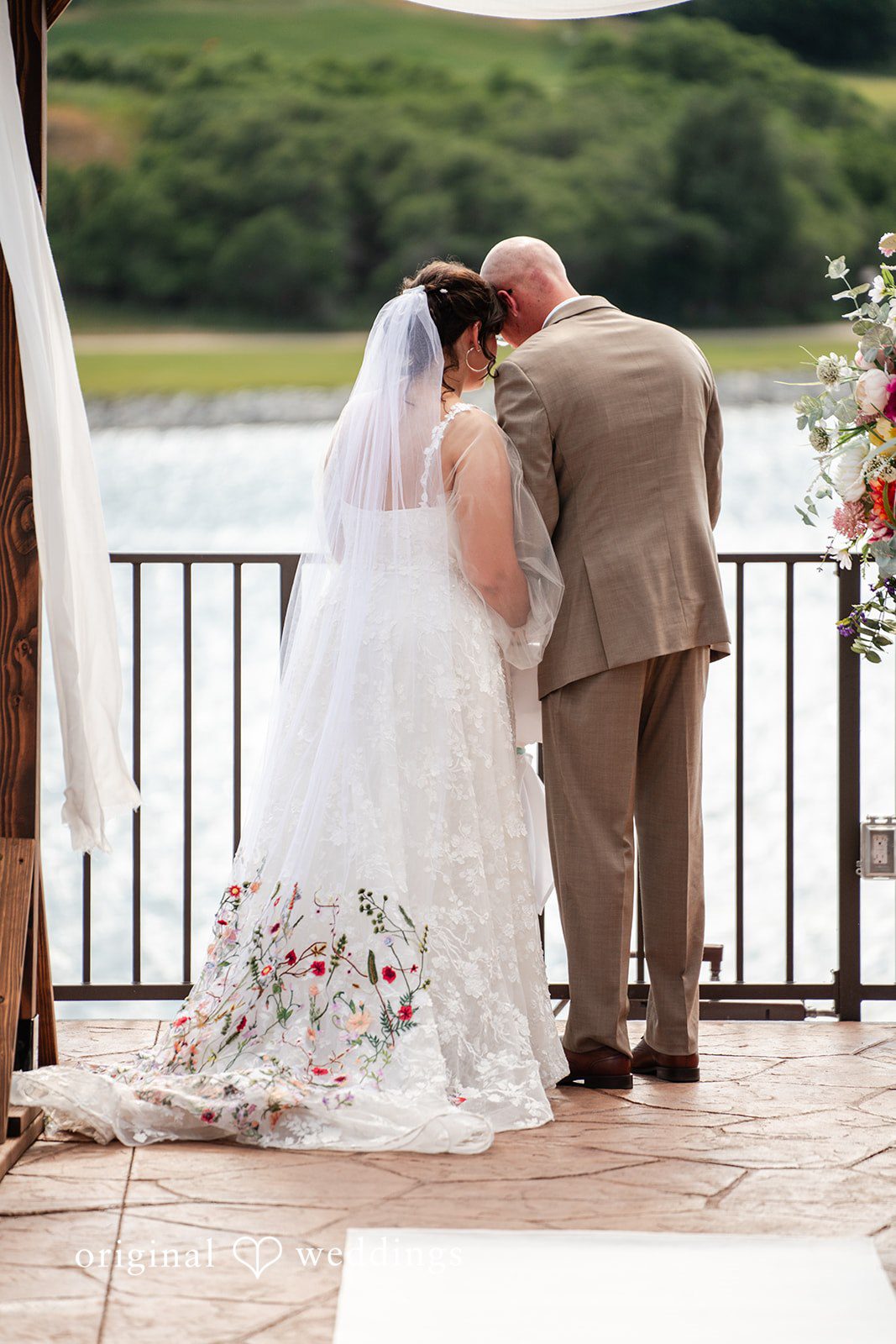Mckenna + Ryan A bride and groom standing together at a railing looking at the view.