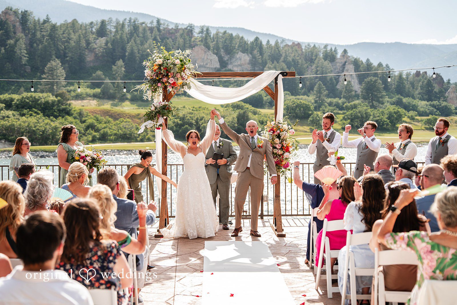 Mckenna + Ryan A wedding ceremony in progress with guests watching from rows of chairs.