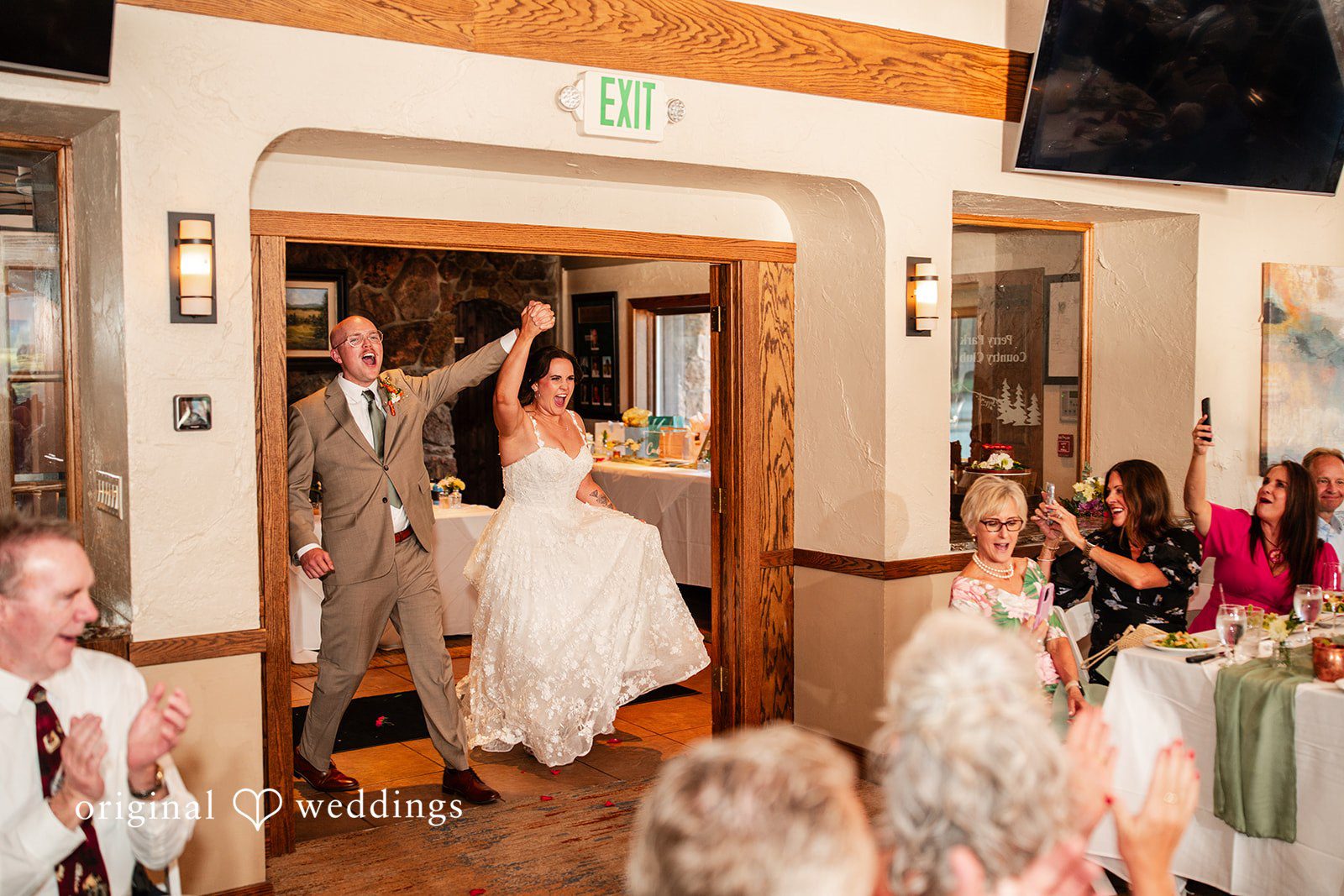 Mckenna + Ryan A bride and groom making their grand entrance into a reception hall.