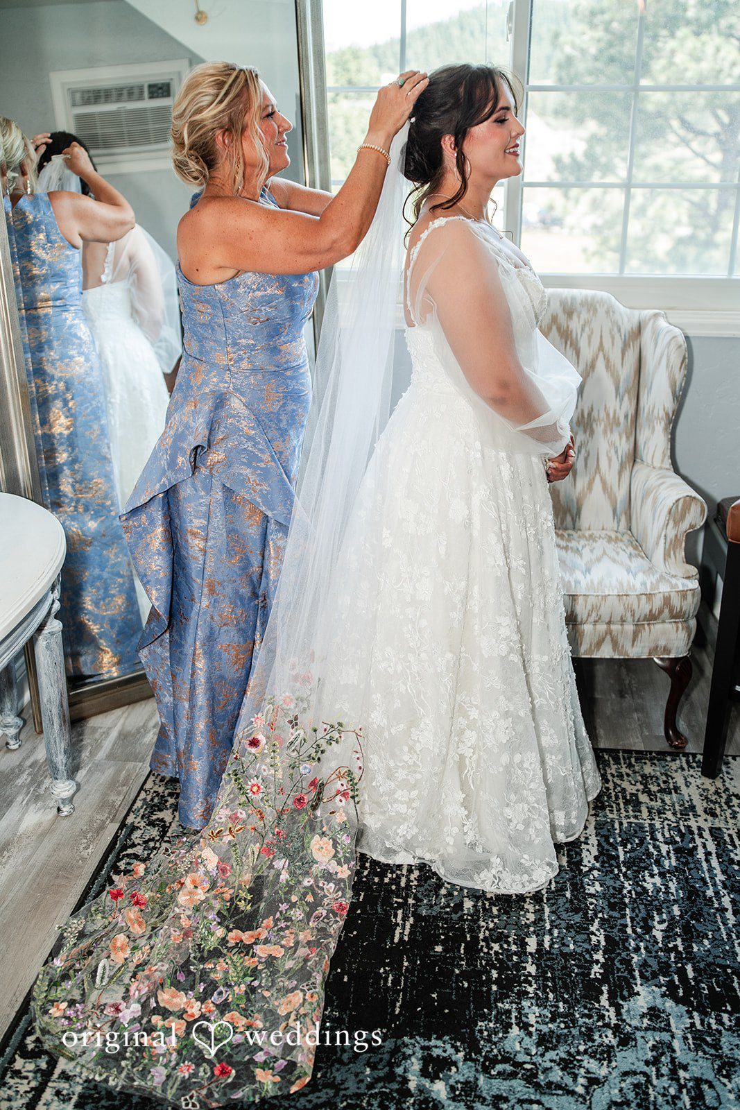 Mckenna + Ryan A bride having her wedding dress and veil adjusted.
