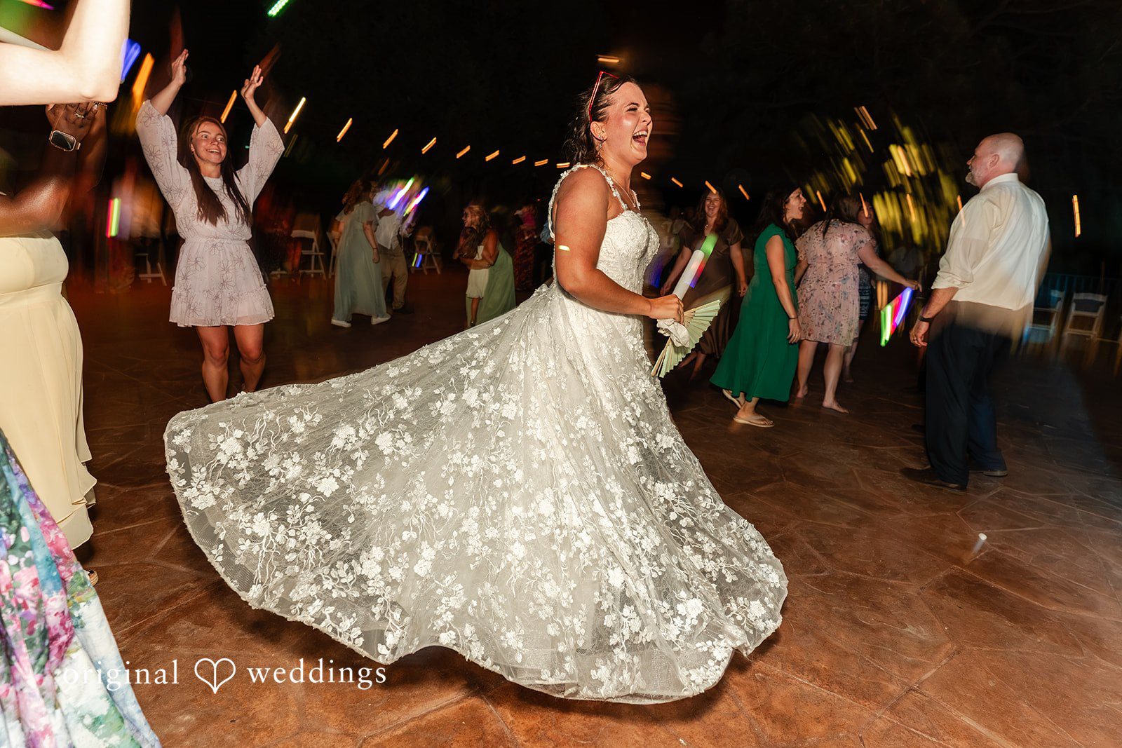 Mckenna + Ryan A bride spinning on the dance floor in a glittering wedding gown.