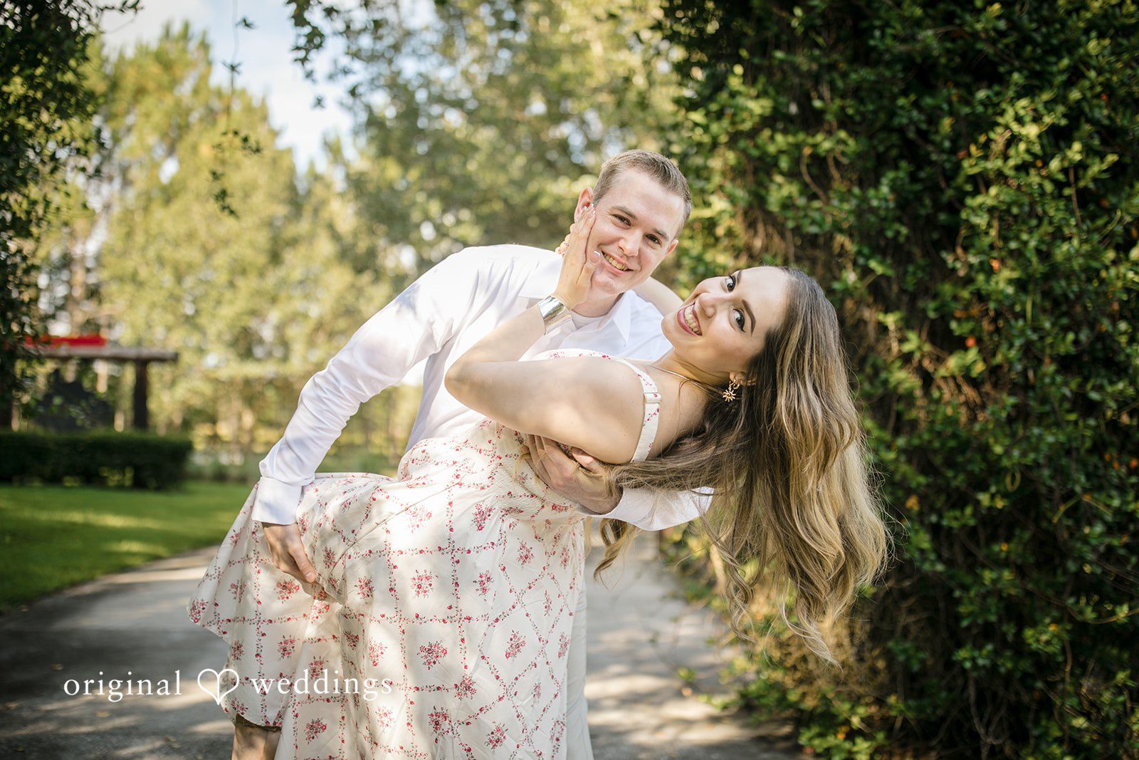 Man dipping a woman backward as they share a playful moment.