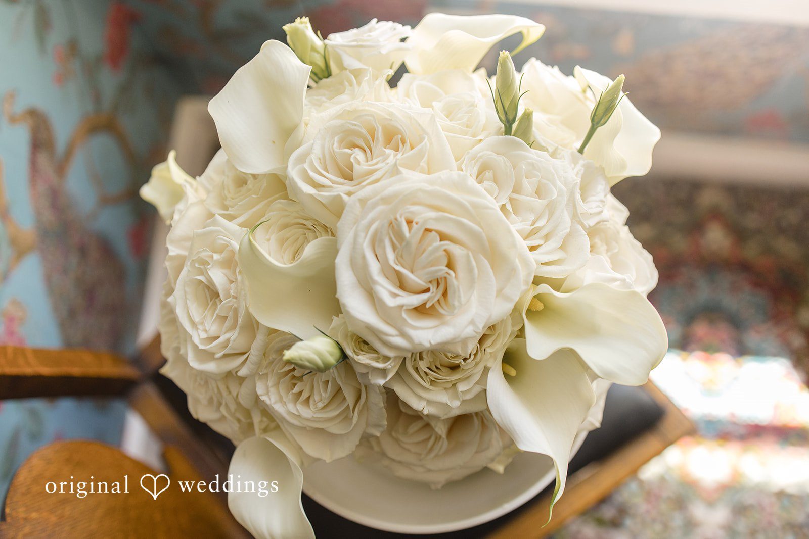 Madelyn + Connor A close-up view of a bridal bouquet composed entirely of white roses.