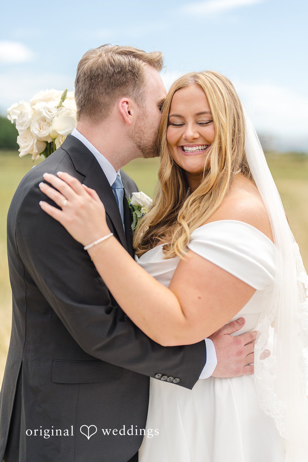 Madelyn + Connor A close-up portrait of a smiling bride and groom sharing an embrace.