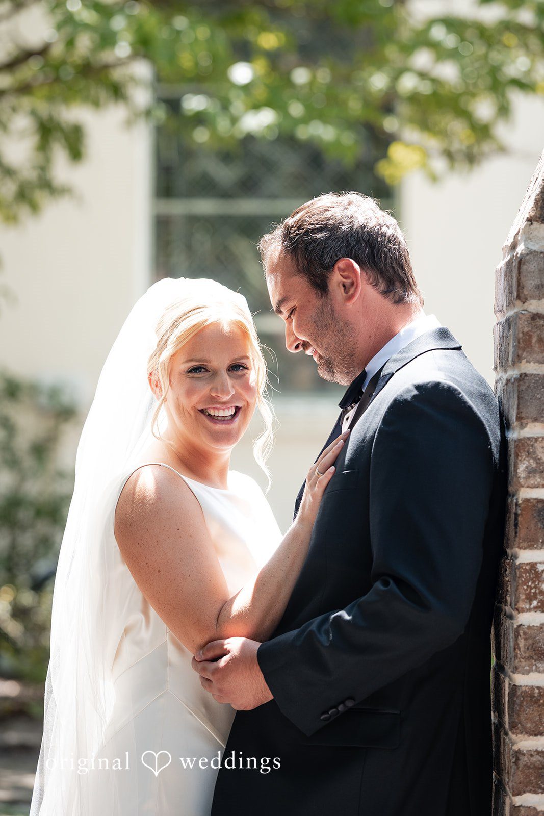 Maggie + Taylor A groom smiles warmly at his bride during a close portrait session.