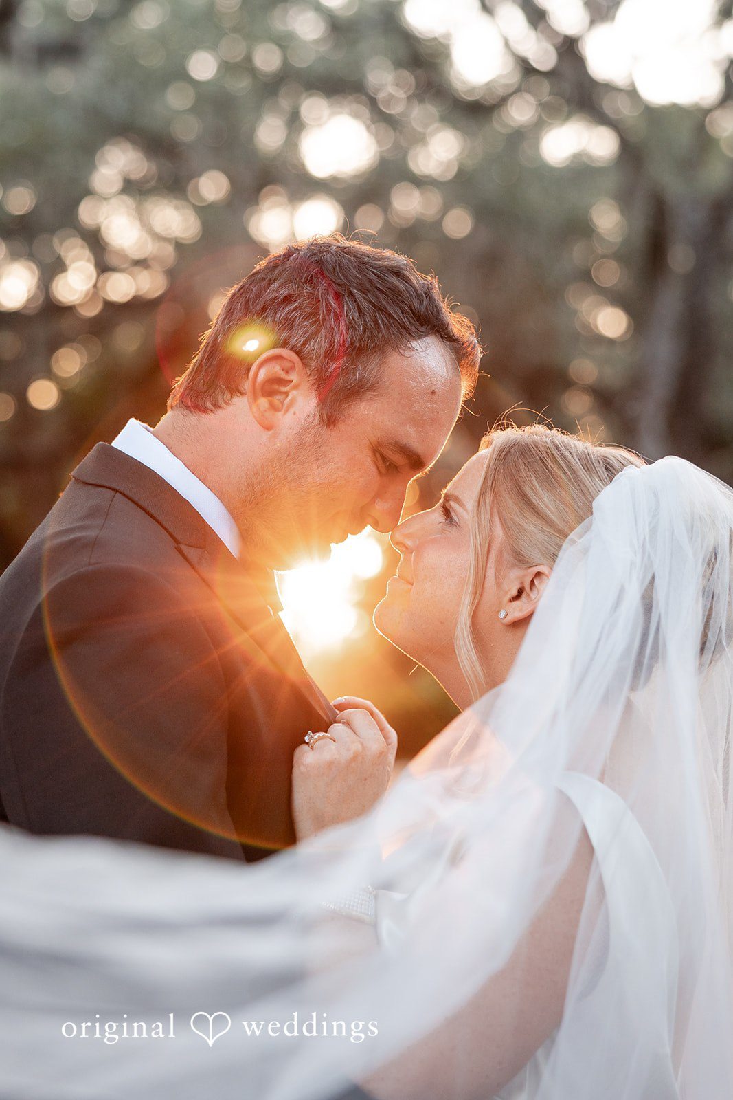 Maggie + Taylor Close-up of a groom looking lovingly at his bride during sunset.