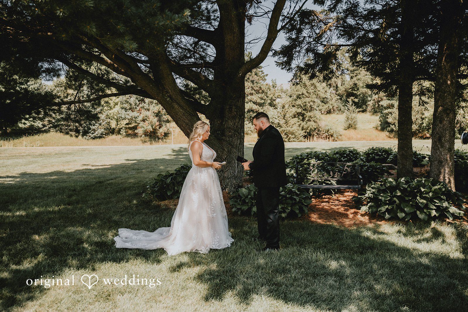 Samantha + Peyton Bride and groom standing near a large tree.