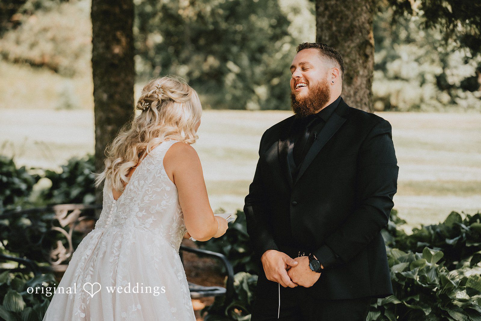 Samantha + Peyton Bride and groom facing each other on a grassy field.