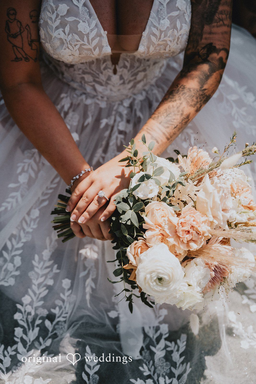 Samantha + Peyton Bride holding a soft pink and white floral bouquet.