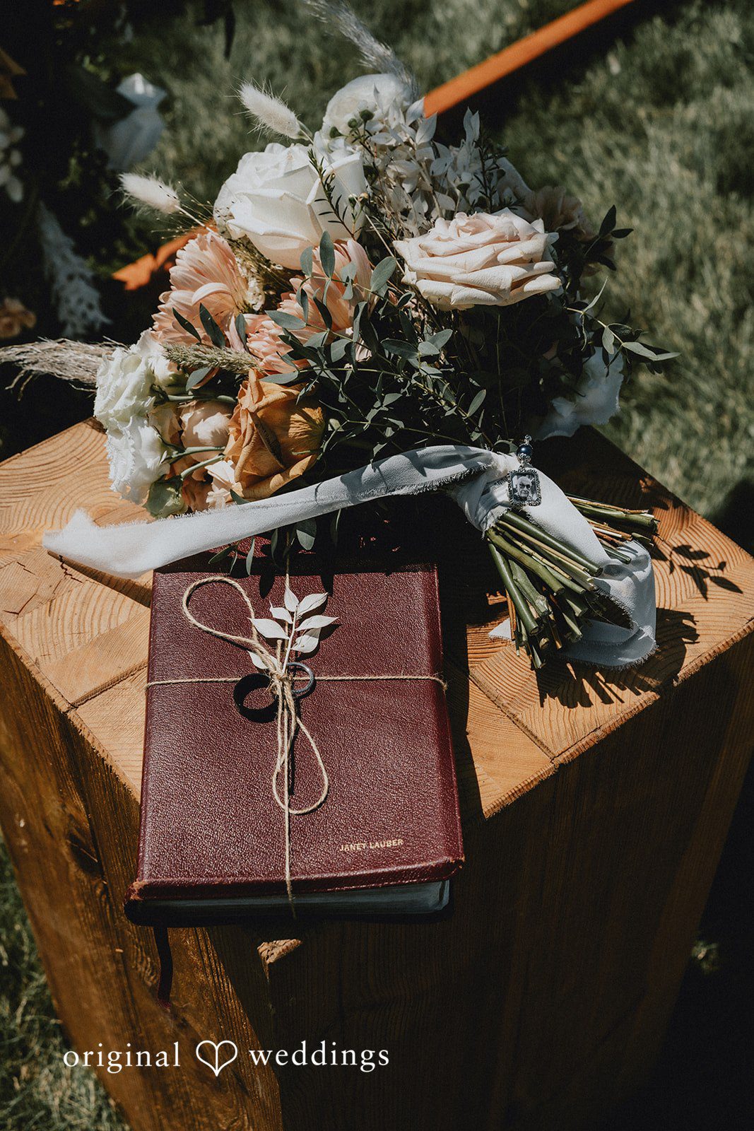 Samantha + Peyton Wooden table featuring a vintage book and floral arrangement.