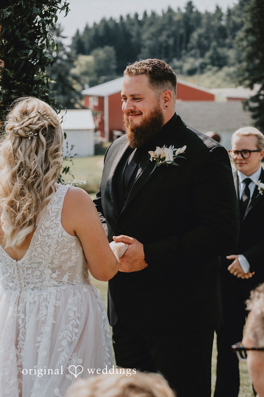 Samantha + Peyton Groom smiling at the bride during a reception.
