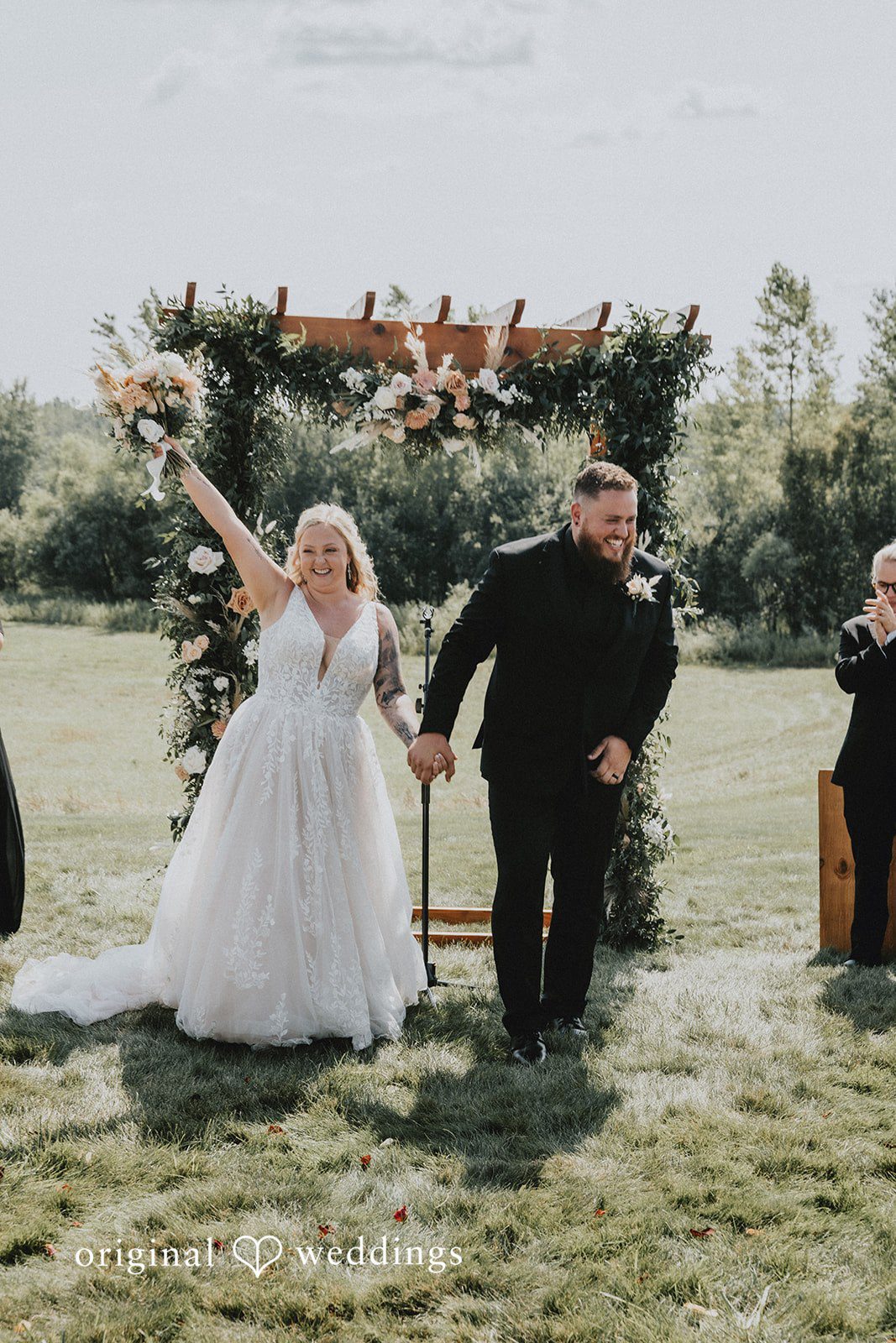 Samantha + Peyton Newlyweds celebrating as they walk down the aisle together.