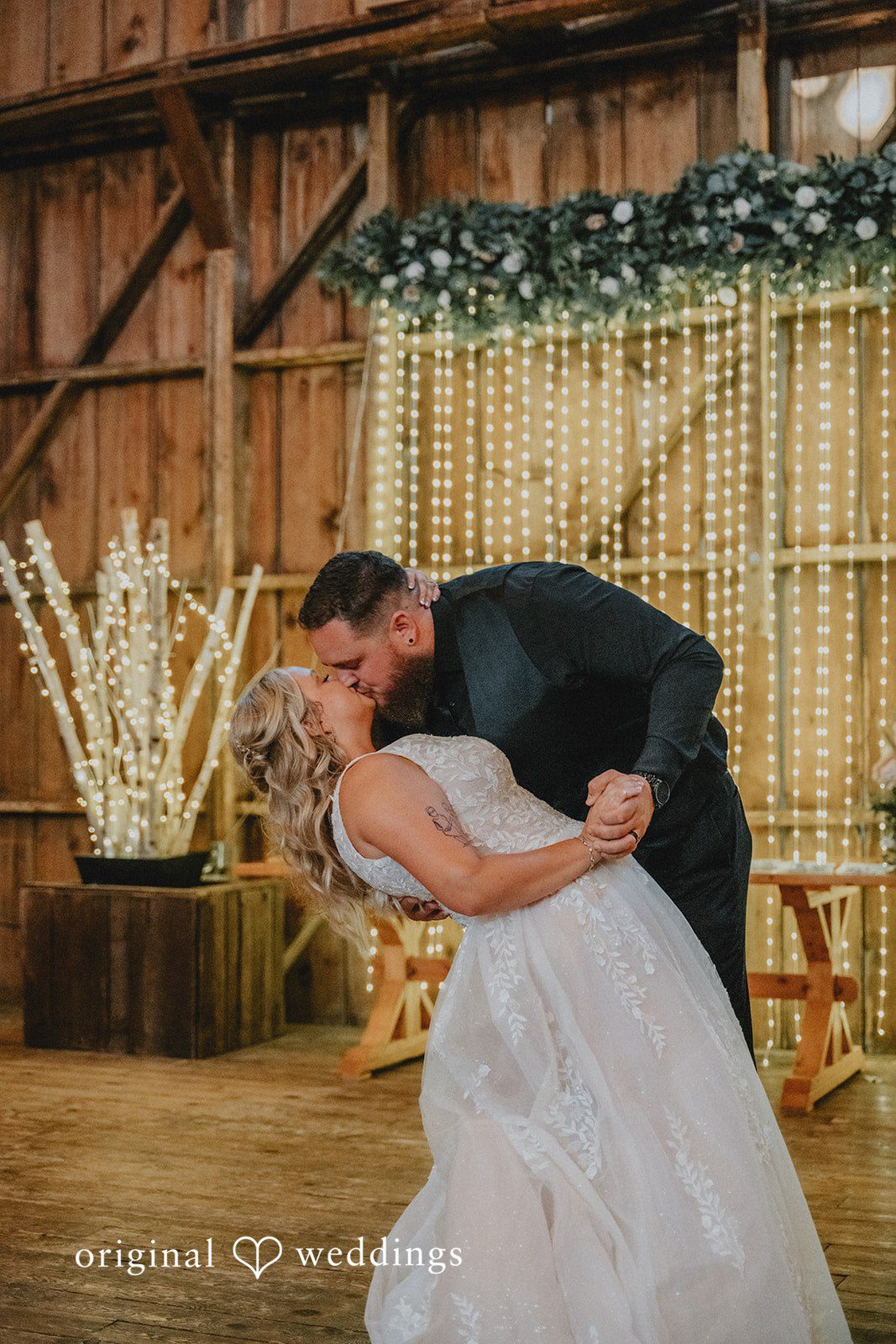 Samantha + Peyton Groom dipping the bride while sharing a kiss on the dance floor.