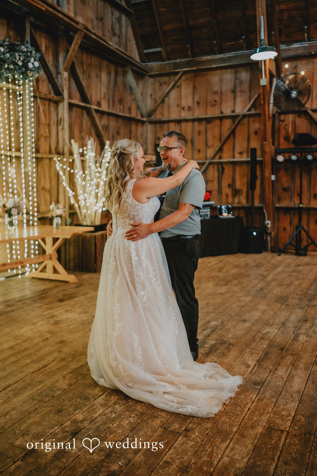 Samantha + Peyton Bride dancing with a wedding guest on a polished wooden floor.