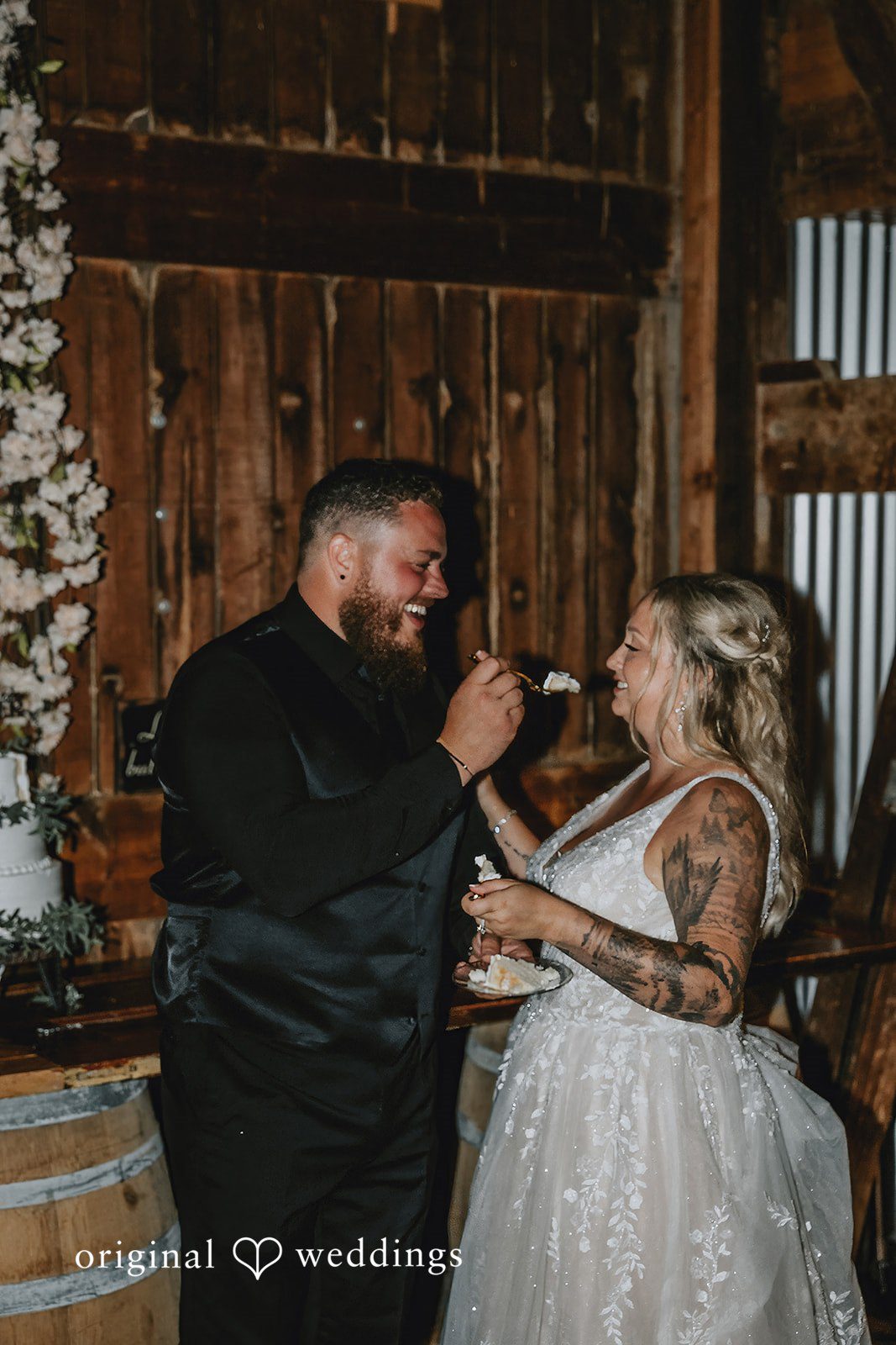 Samantha + Peyton Bride and groom talking and smiling together on a wooden dance floor.