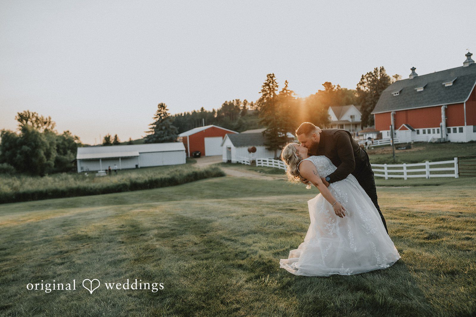 Samantha + Peyton Groom dipping the bride during a sunset embrace on a farm.