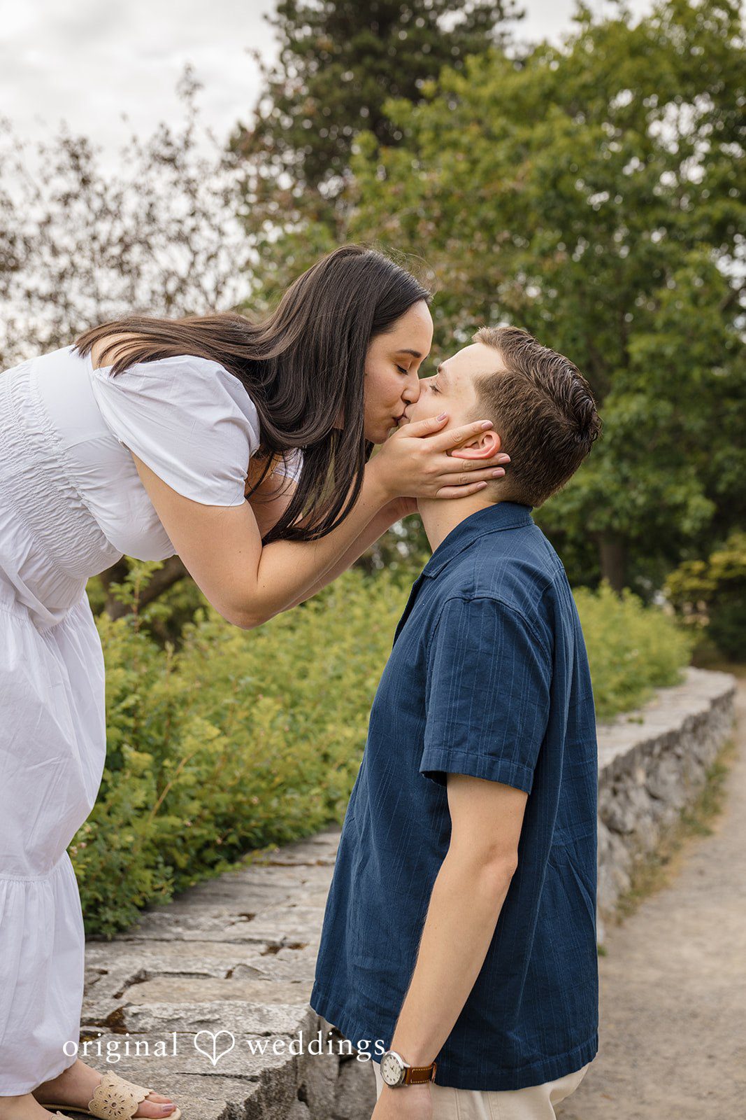 A close-up shot of a woman leaning over to kiss a man.
