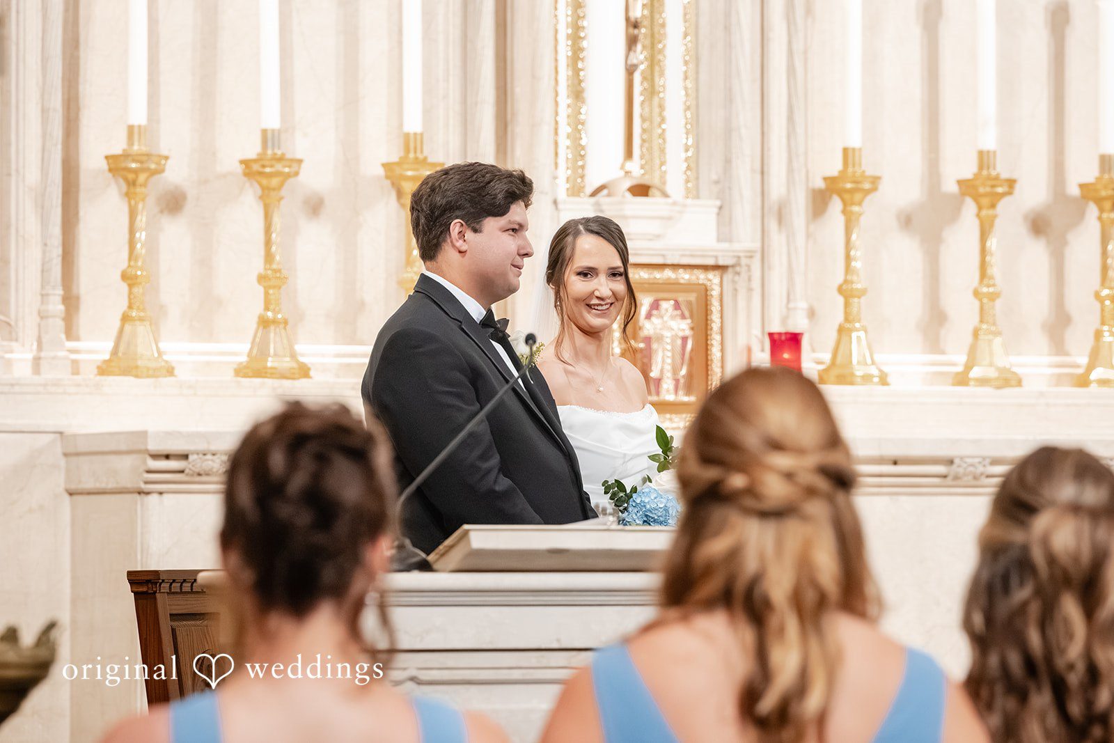 Mark + Caroline The bride and groom standing at the altar facing the officiant during the ceremony.