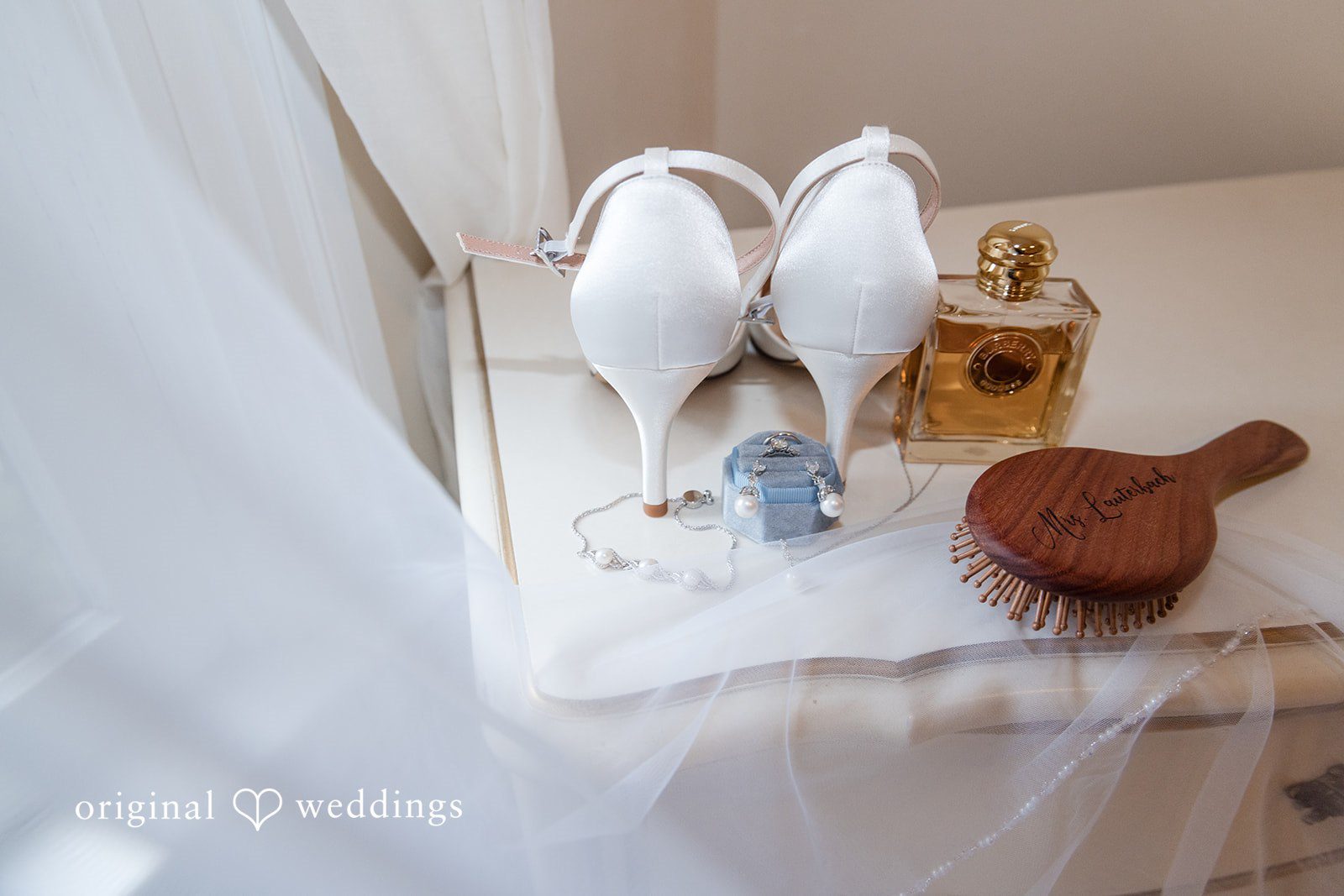 Mark + Caroline Wedding shoes and bridal accessories arranged neatly on a surface.