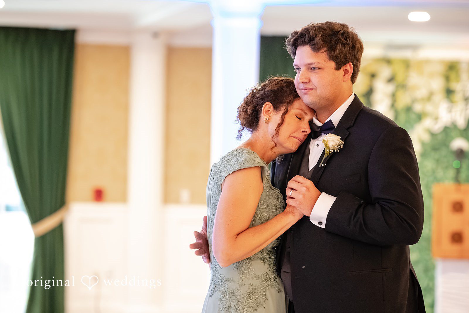 Mark + Caroline The groom sharing an emotional dance with a woman in a grey dress at the reception.