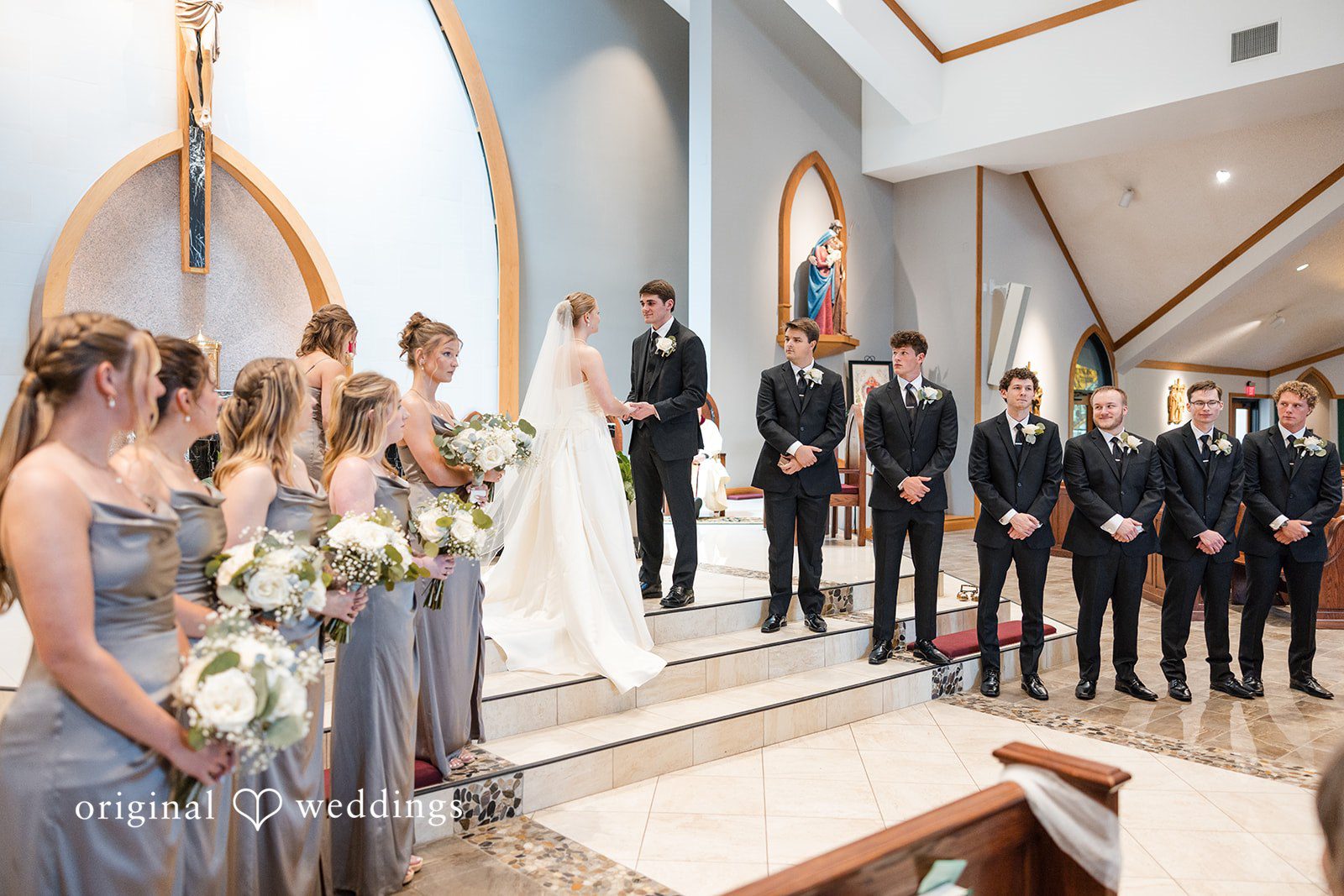 Cora + Michael Elegant bride and groom looking at each other while holding hands at the Emerald Event Center