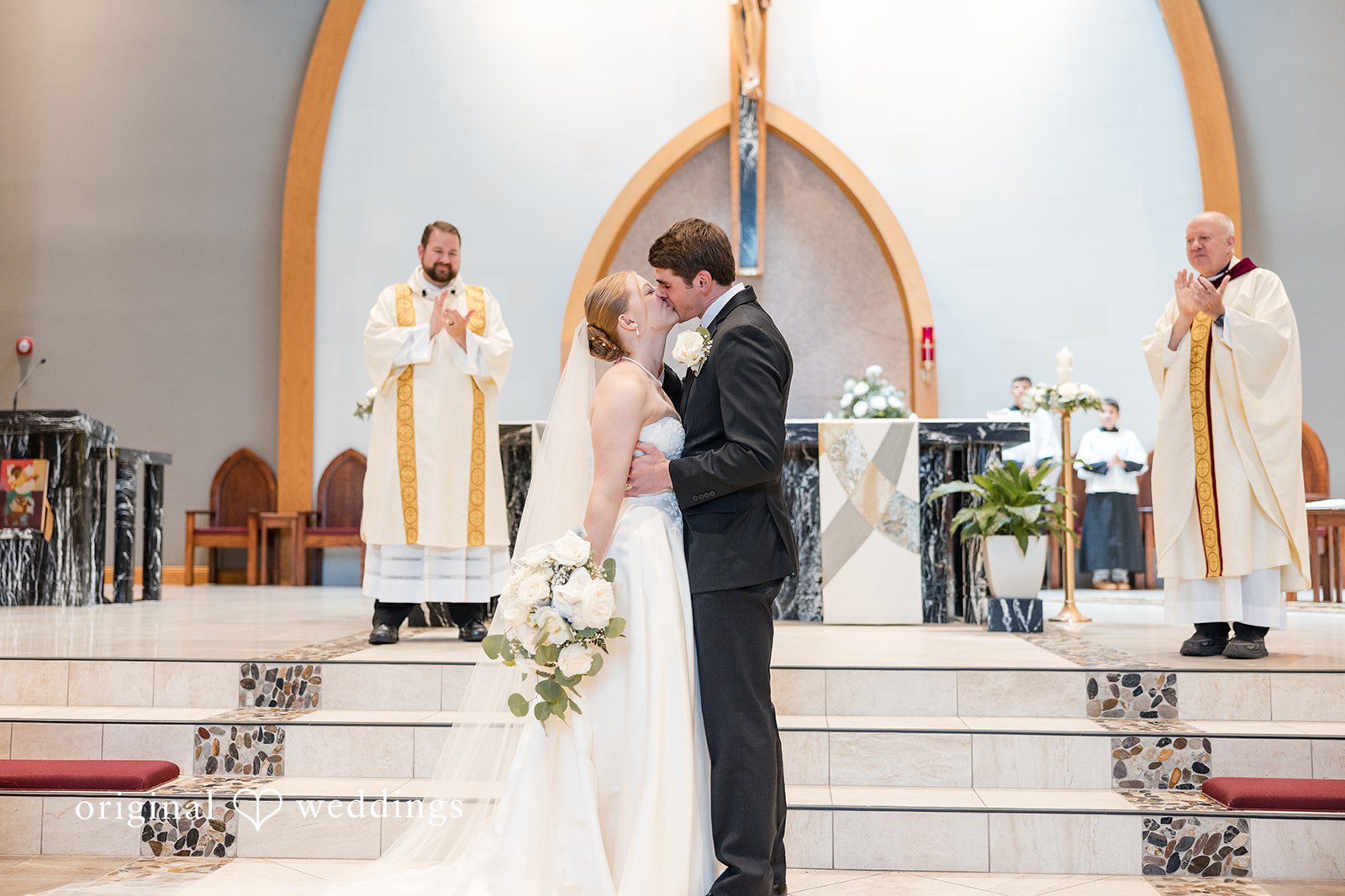 Cora + Michael Elegant bride and groom kiss moment at the Emerald Event Center