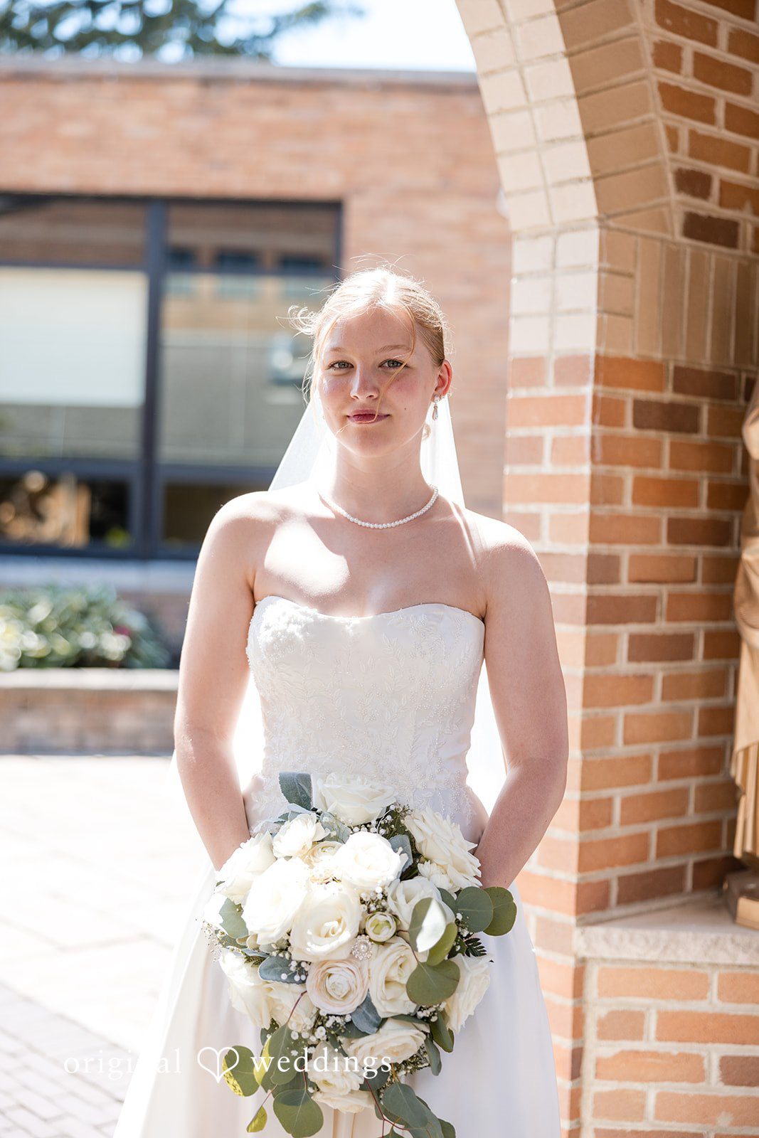 Cora + Michael Elegant bride holding bouquet at the Emerald Event Center