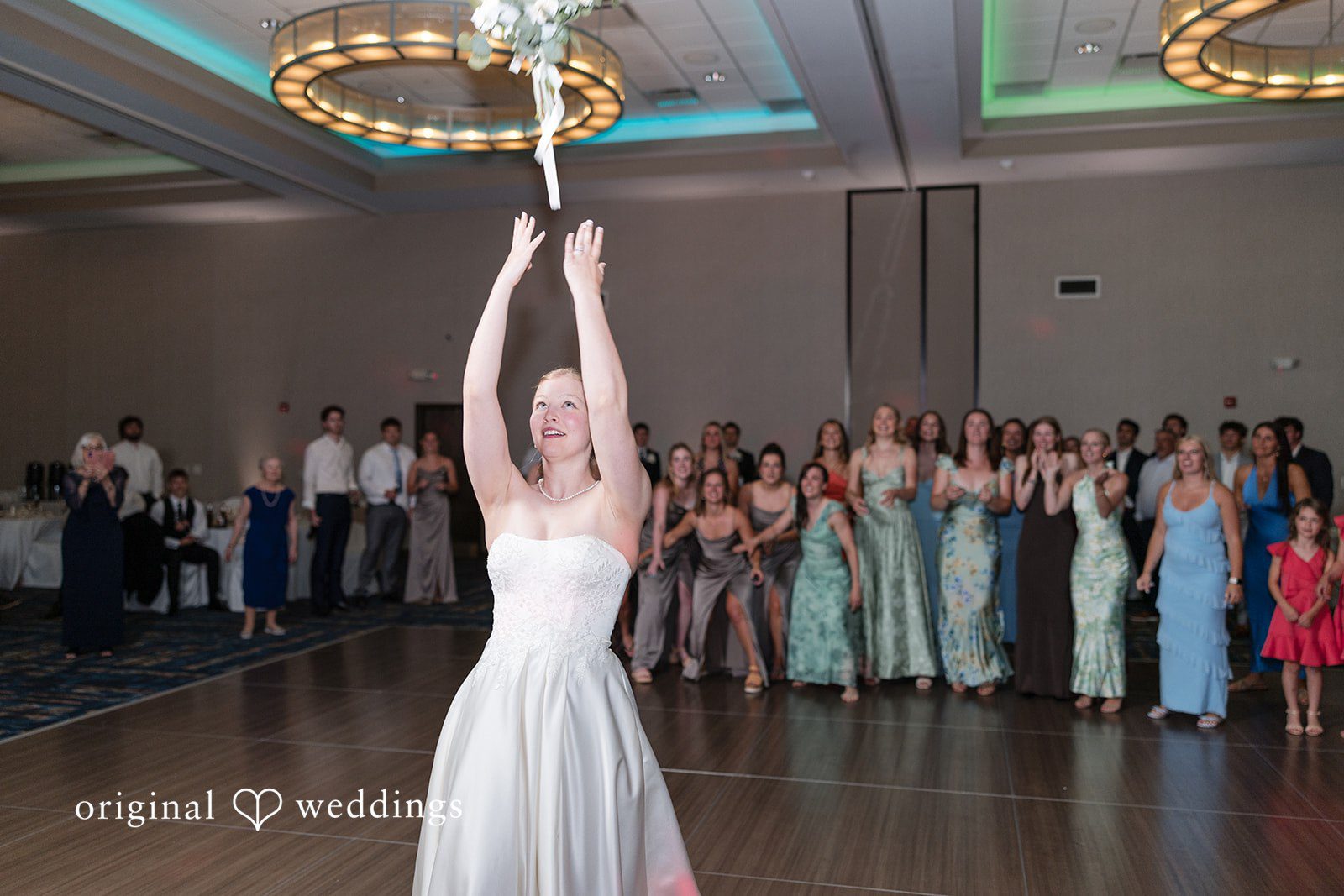 Cora + Michael Elegant bride throwing bouquet photography at the Emerald Event Center