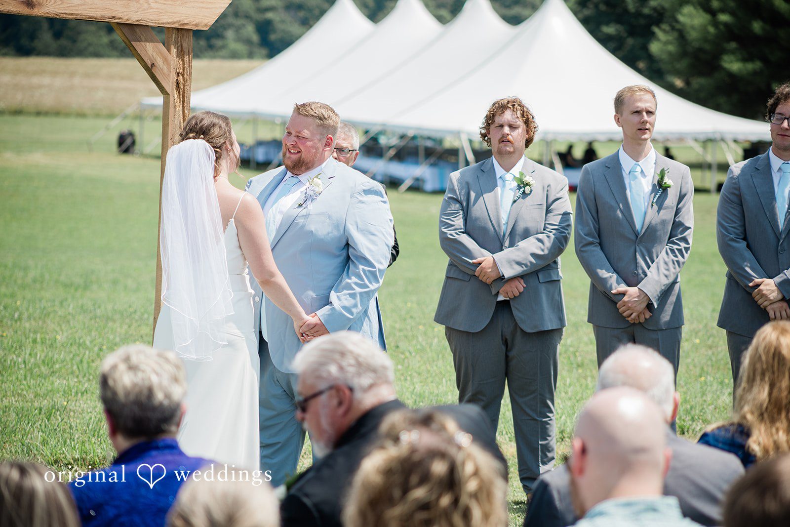 Michaela + Jake A bride and groom stand at the altar during their wedding ceremony.