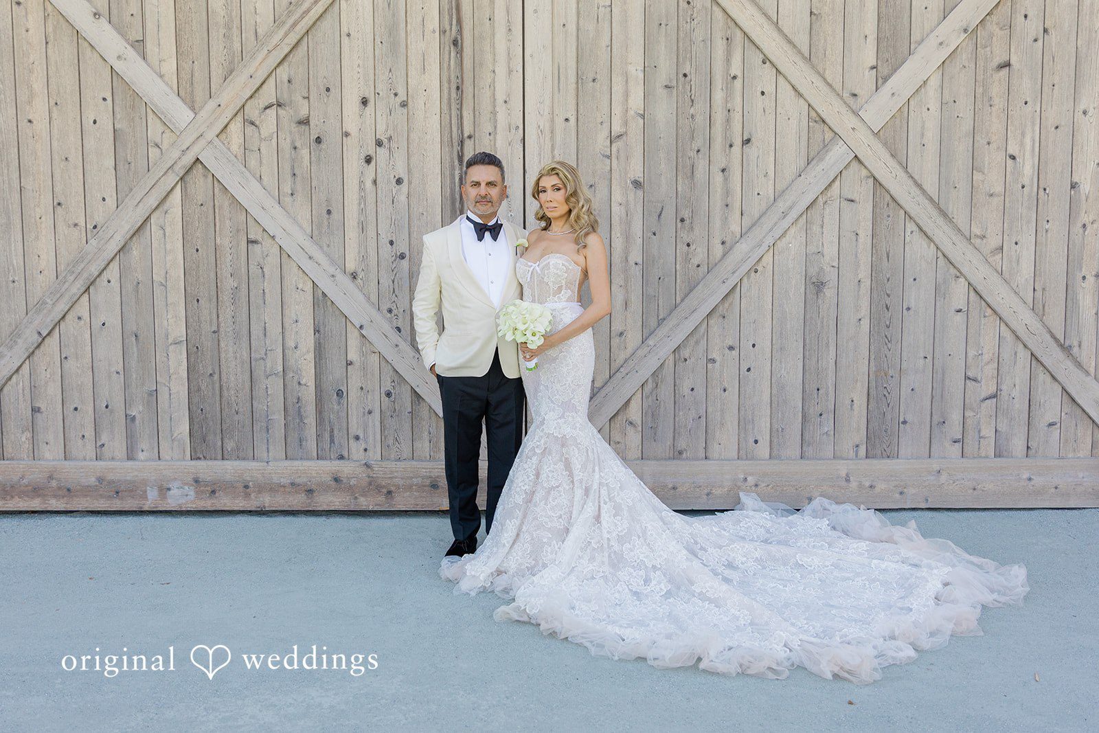 Mehul + Nazanin Our San Francisco wedding photographers captured a romantic portrait of the couple by the wooden door at the Four Seasons Callistoga
