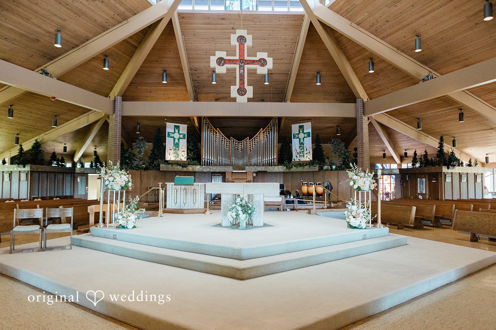 Church altar featuring a central cross and soft stage lighting.