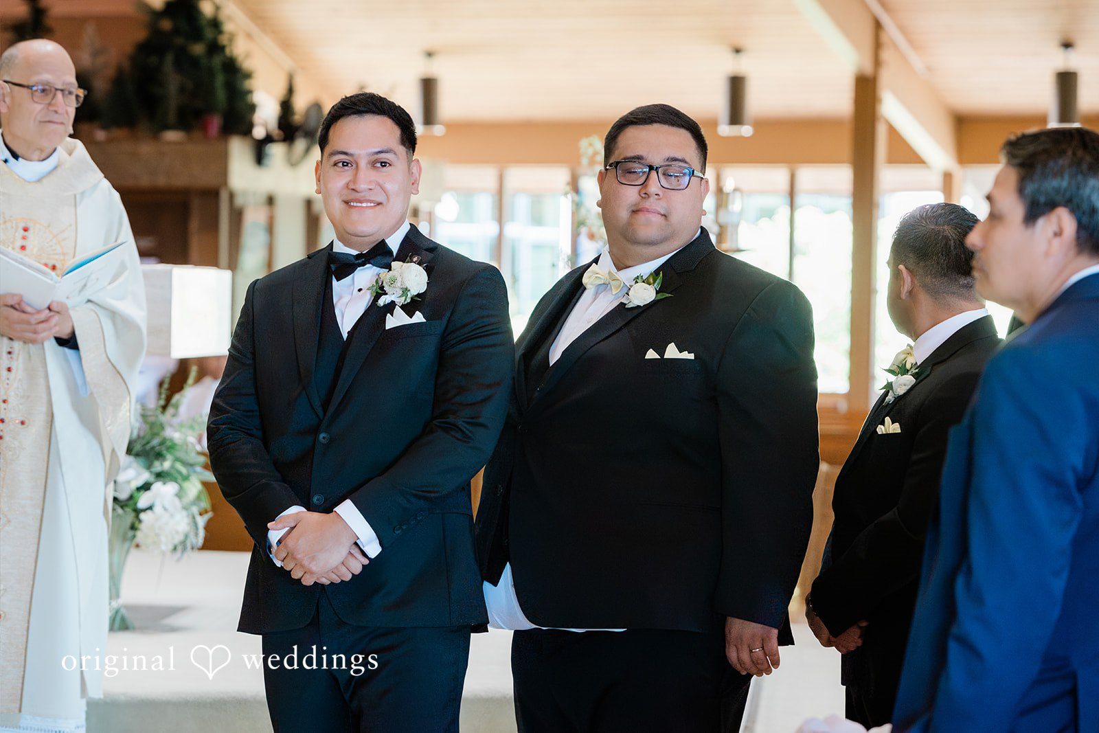 Groom standing at the altar with groomsmen during the ceremony.