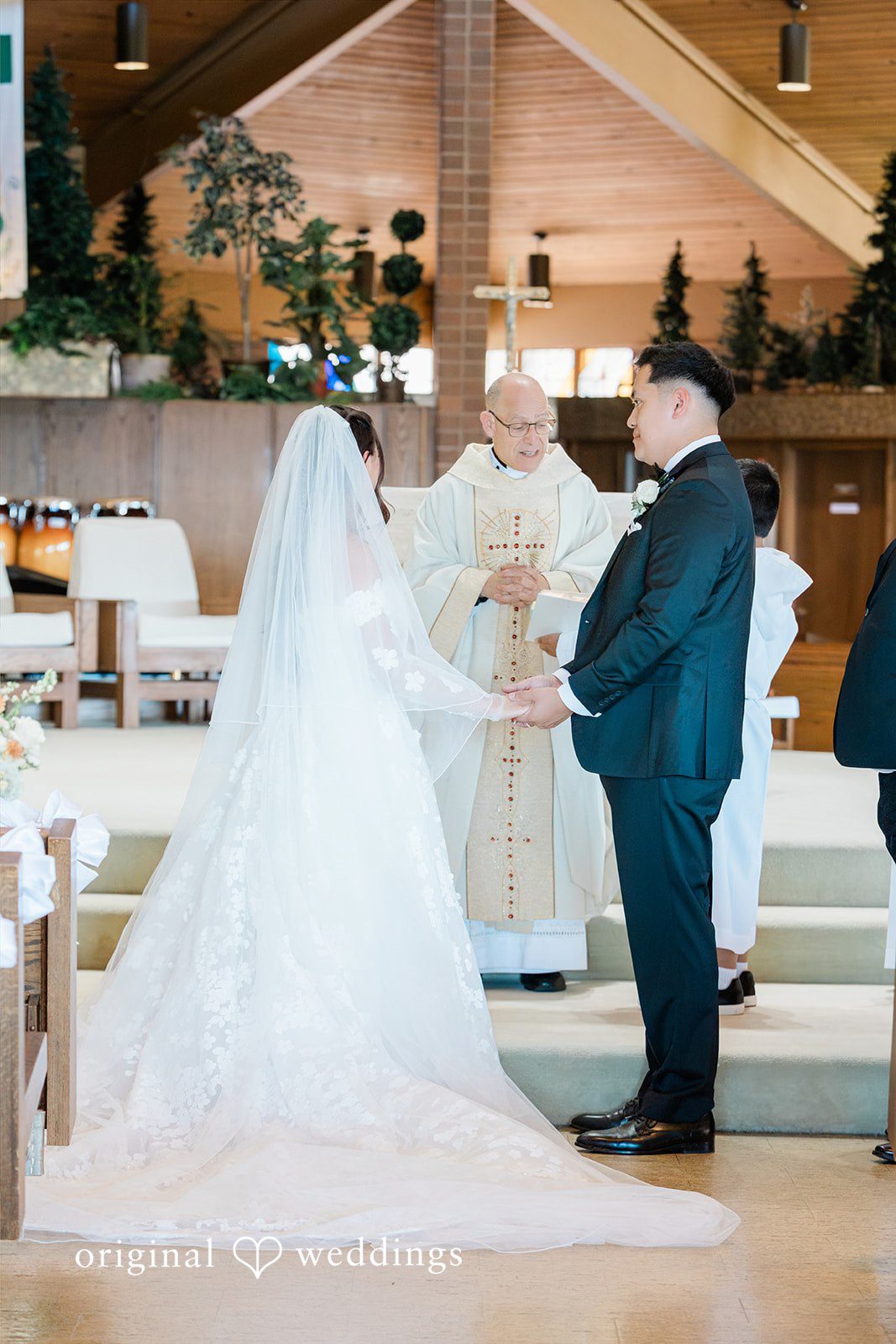 Bride and groom standing before an officiant at the altar.