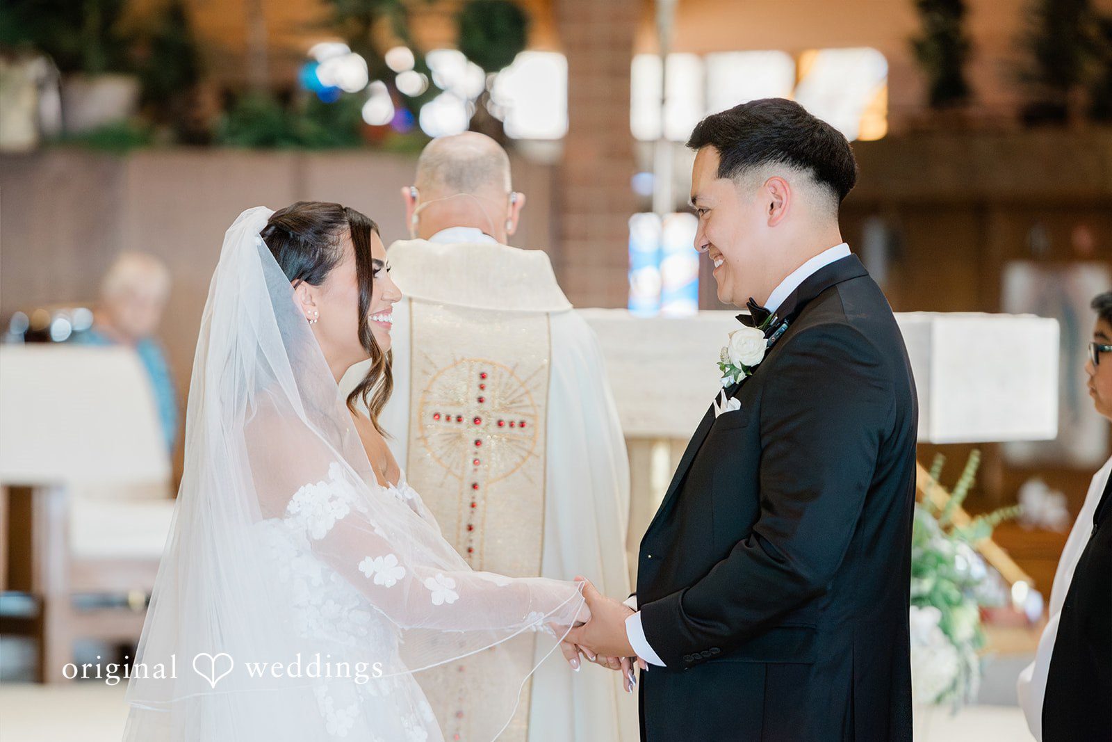 Bride and groom holding hands during their wedding vows.
