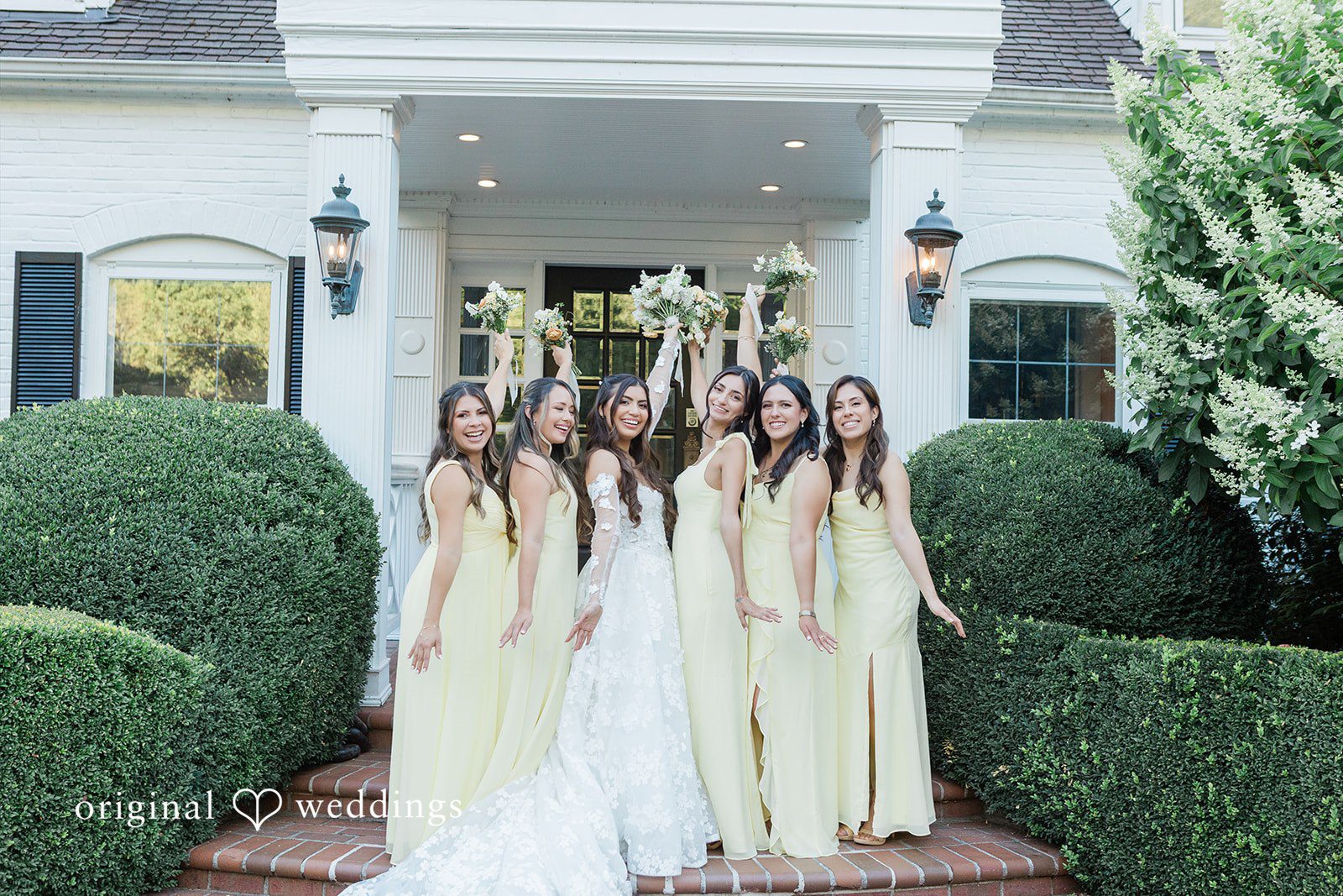 Group of bridesmaids standing together near a white entryway.