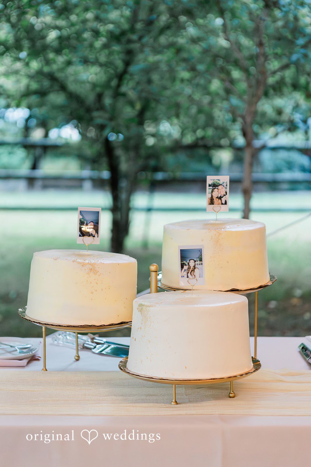 Multi-tiered white wedding cake presented on a simple table.