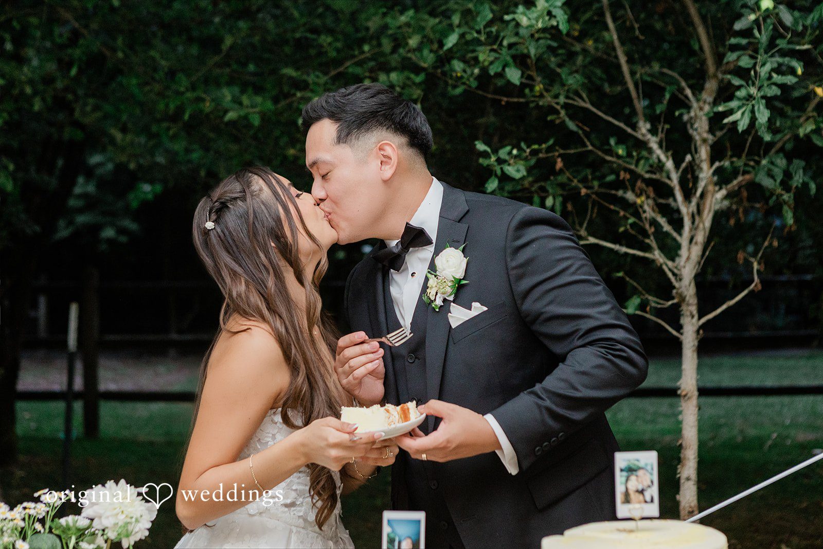 Bride and groom sharing a sweet kiss at their reception.
