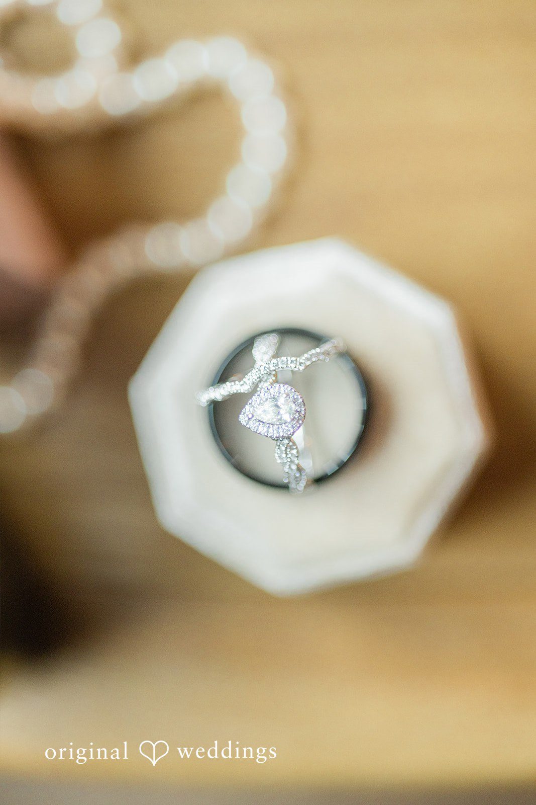 Michelle + Eric A close-up view of wedding rings placed inside a white geometric box.
