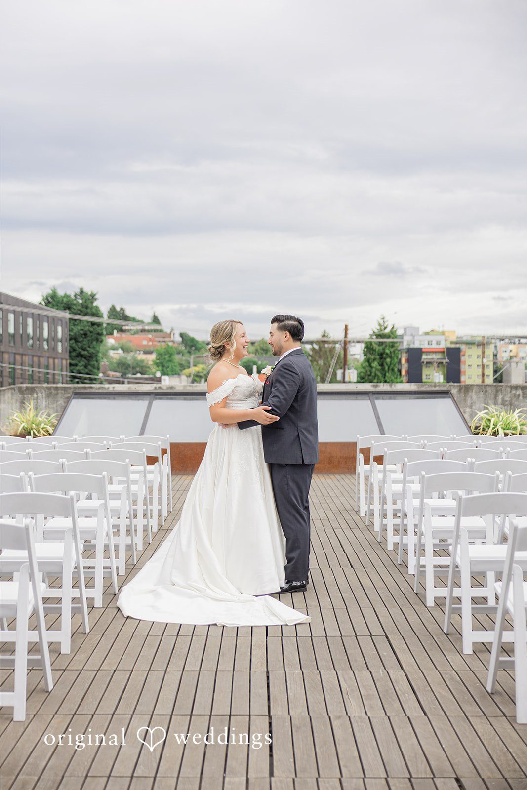 Michelle + Eric A bride and groom standing together on an empty rooftop wedding venue.