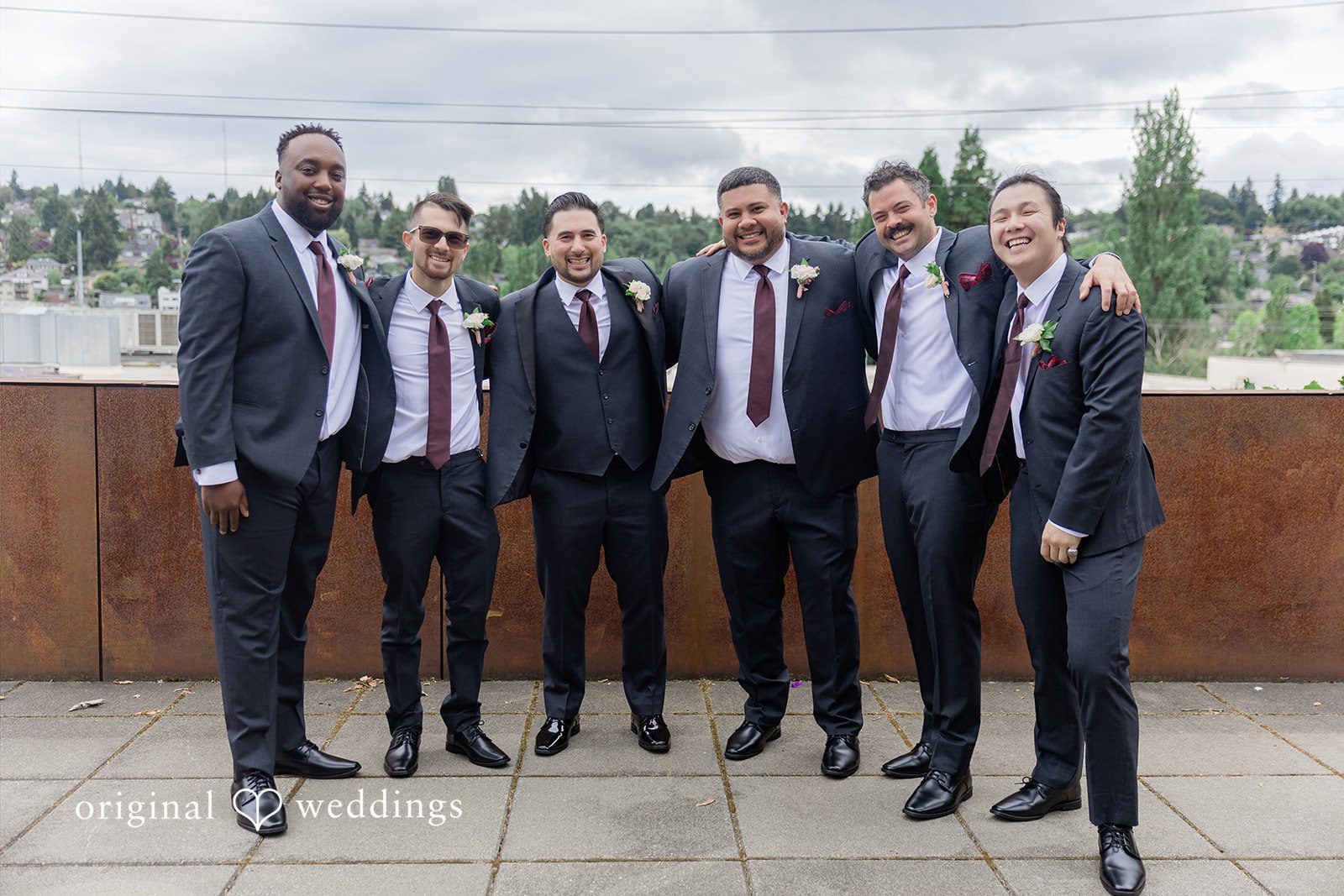 Michelle + Eric A group of groomsmen posing together in dark suits.