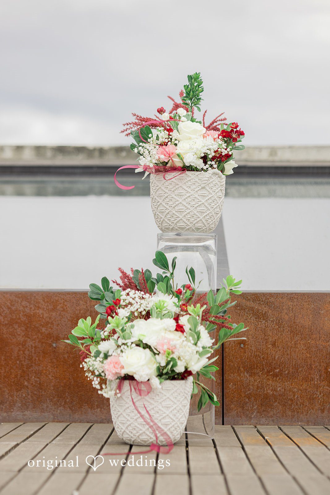 Michelle + Eric Floral arrangements placed on floor at Fremont Foundry.