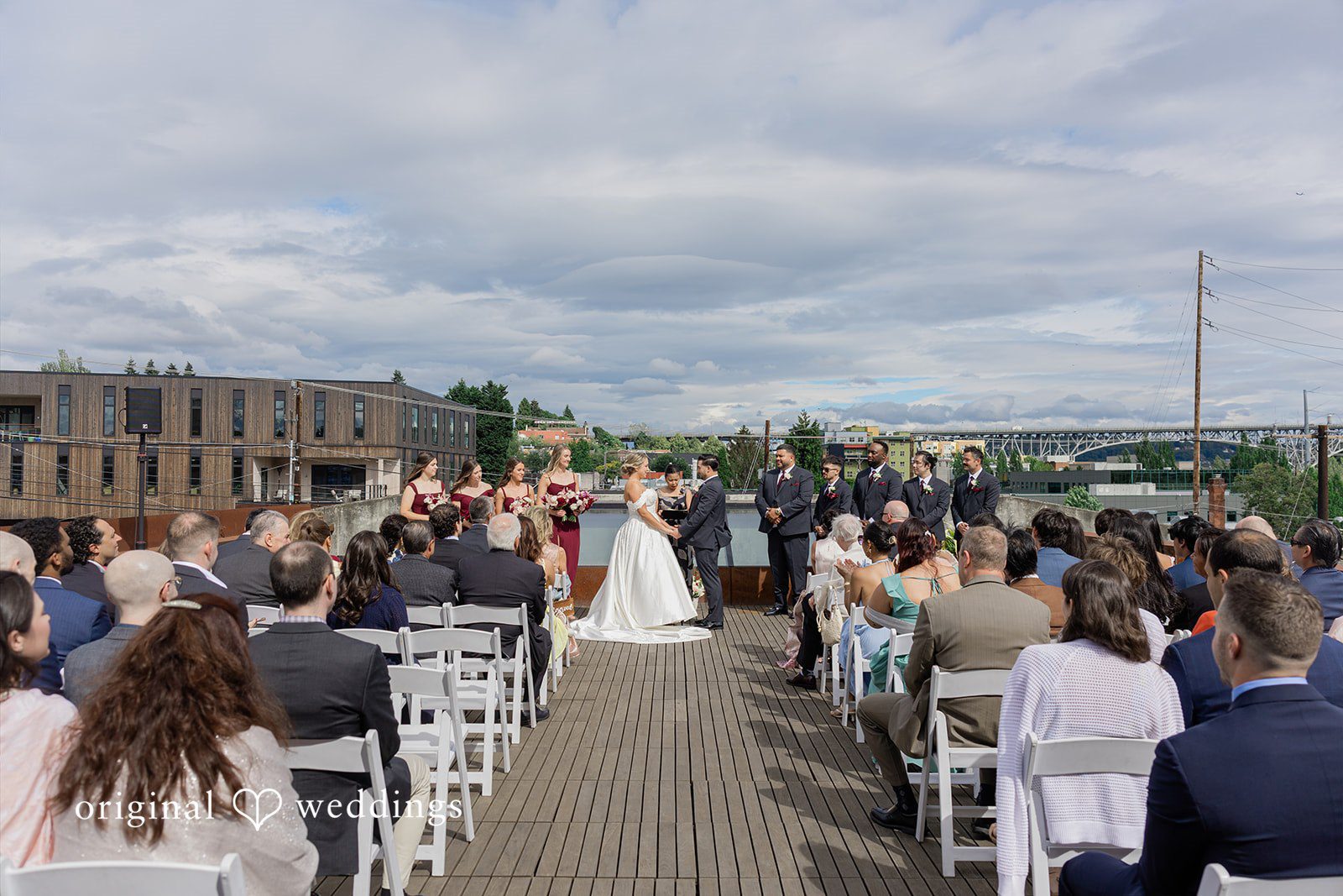 Michelle + Eric A high-angle view of a bride and groom standing at the altar during a rooftop ceremony.