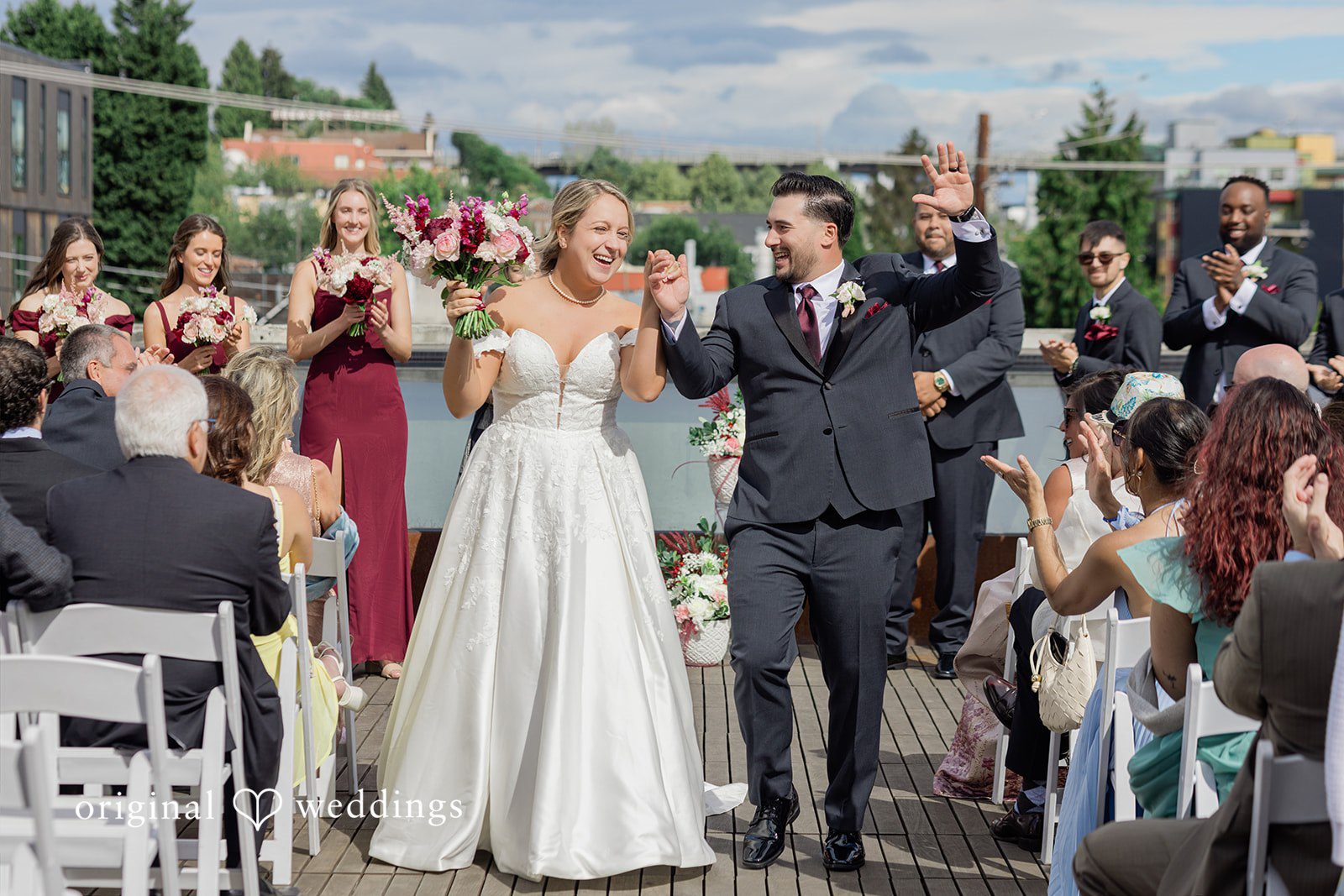 Michelle + Eric A bride and groom walking down the aisle joyfully as guests cheer.