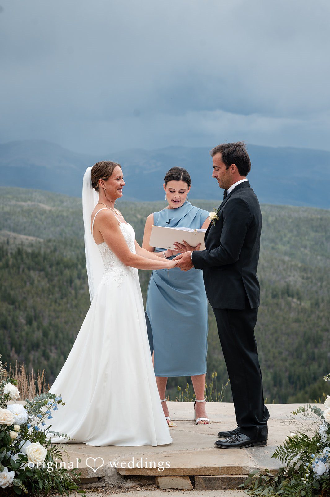 Emilia + Charlie A bride and groom exchanging vows in front of an officiant.