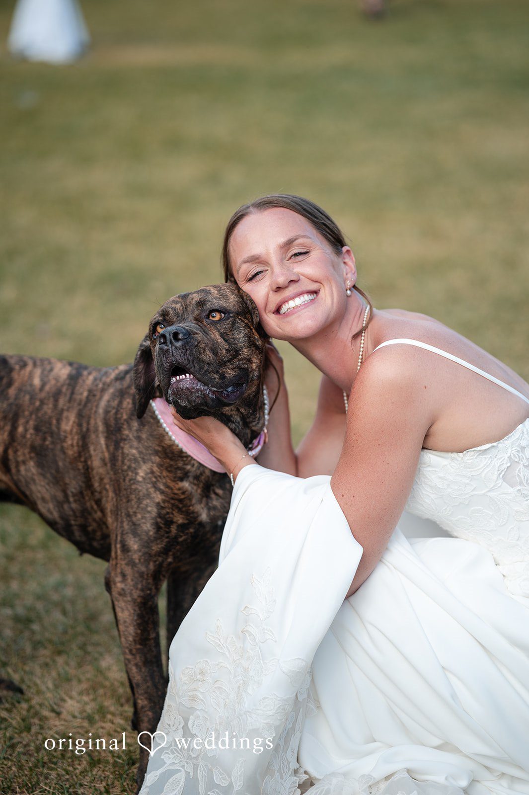 Emilia + Charlie A smiling bride hugging a large black dog.