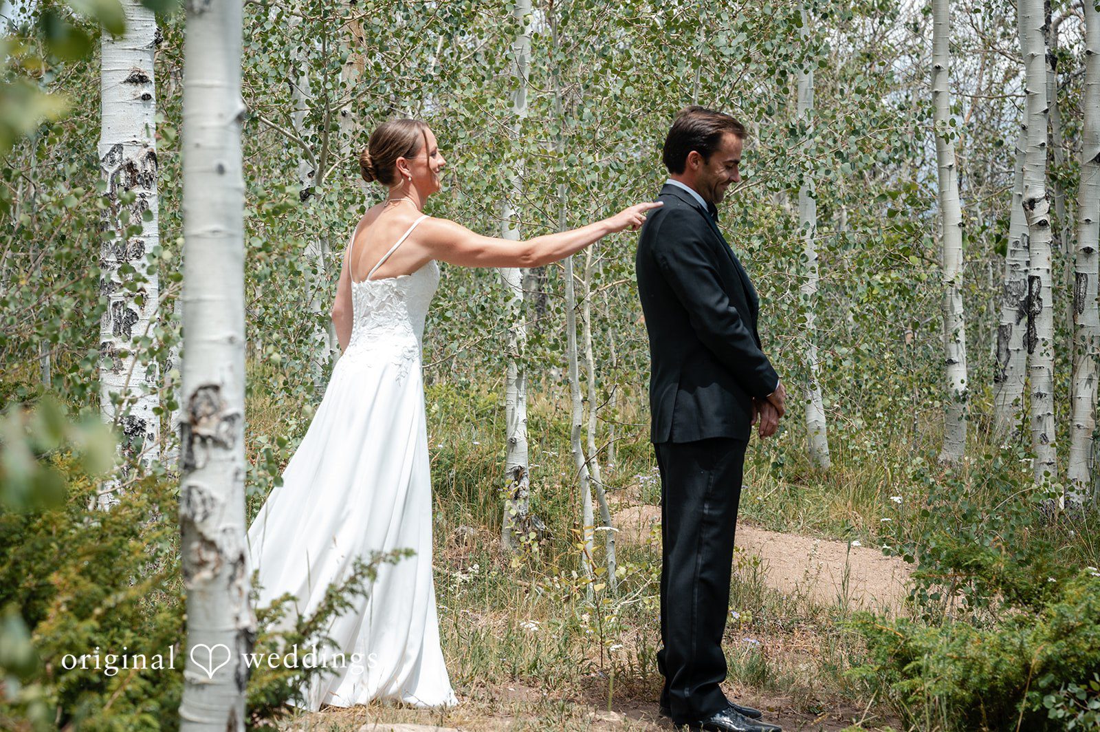 Emilia + Charlie A bride tapping a groom on the shoulder for a first look reveal.