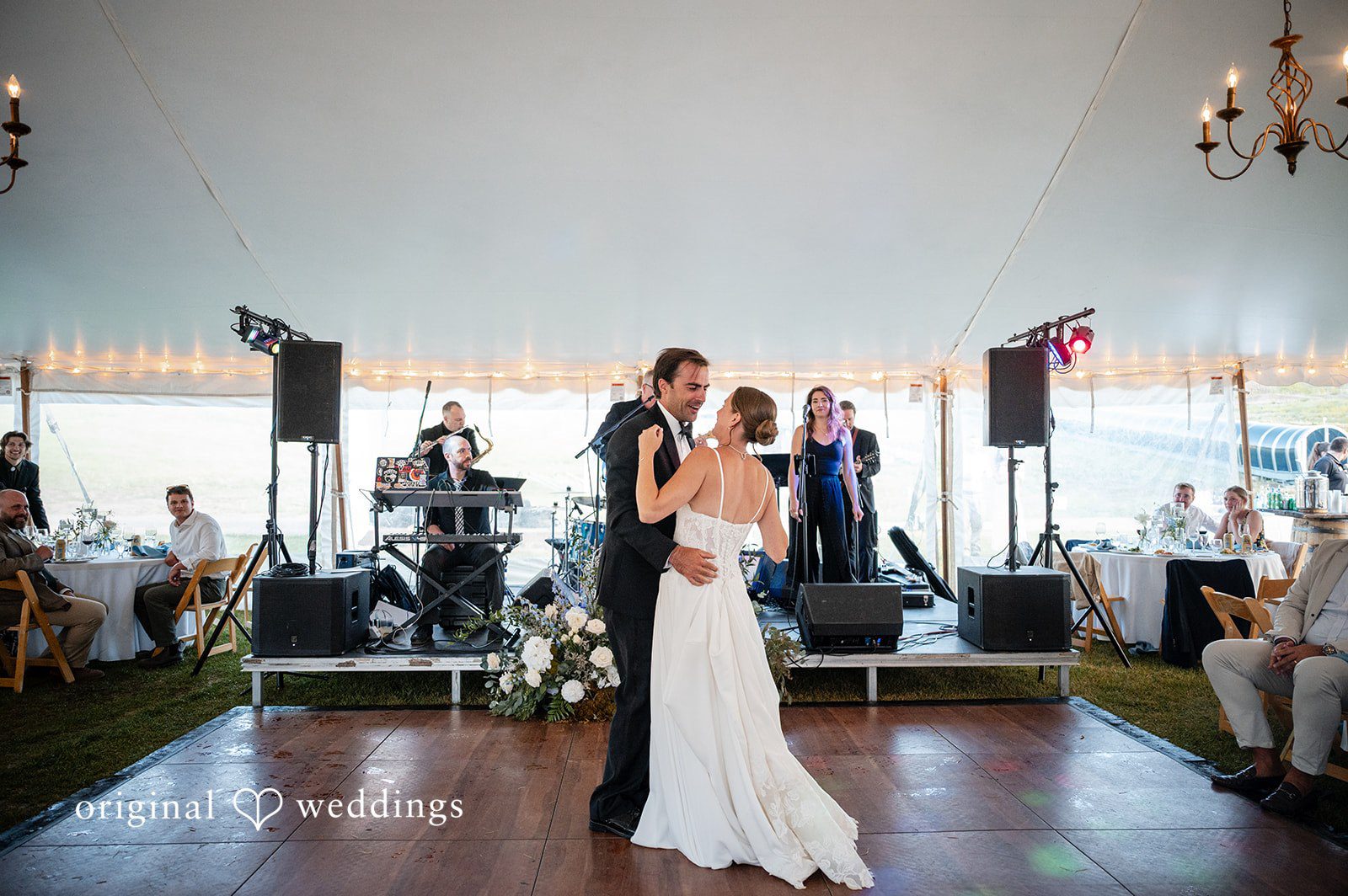 Emilia + Charlie A bride and groom sharing a first dance in an event tent venue.